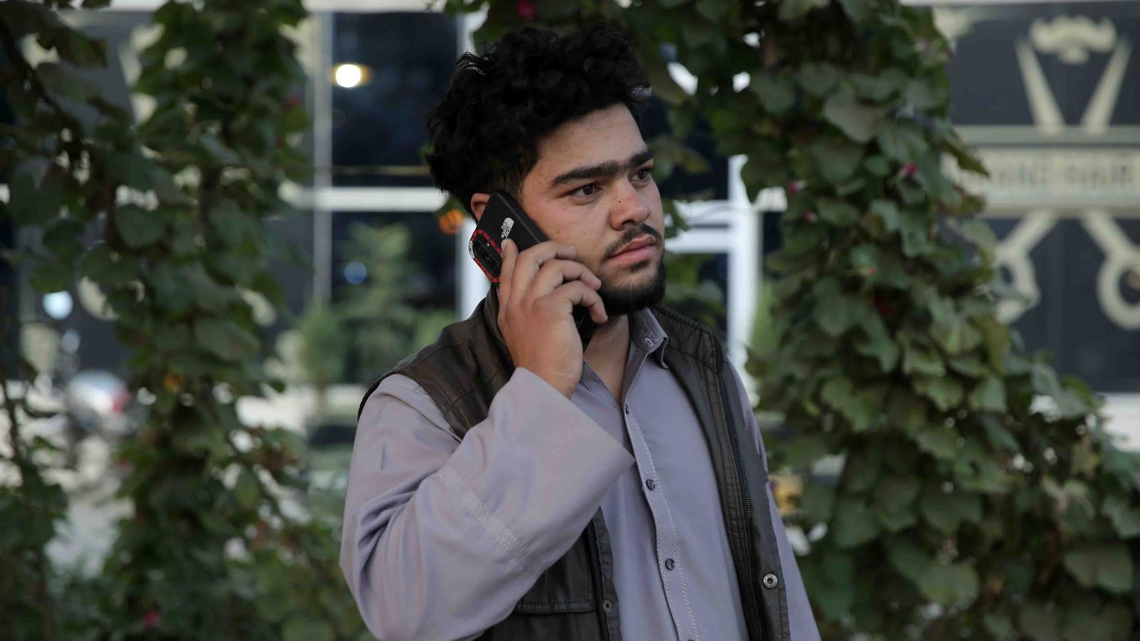 An Afghan man uses a mobile phone after the gradual restoration of internet and telecommunications services in Kabul, cut off for almost three days by order of the Taliban authorities.