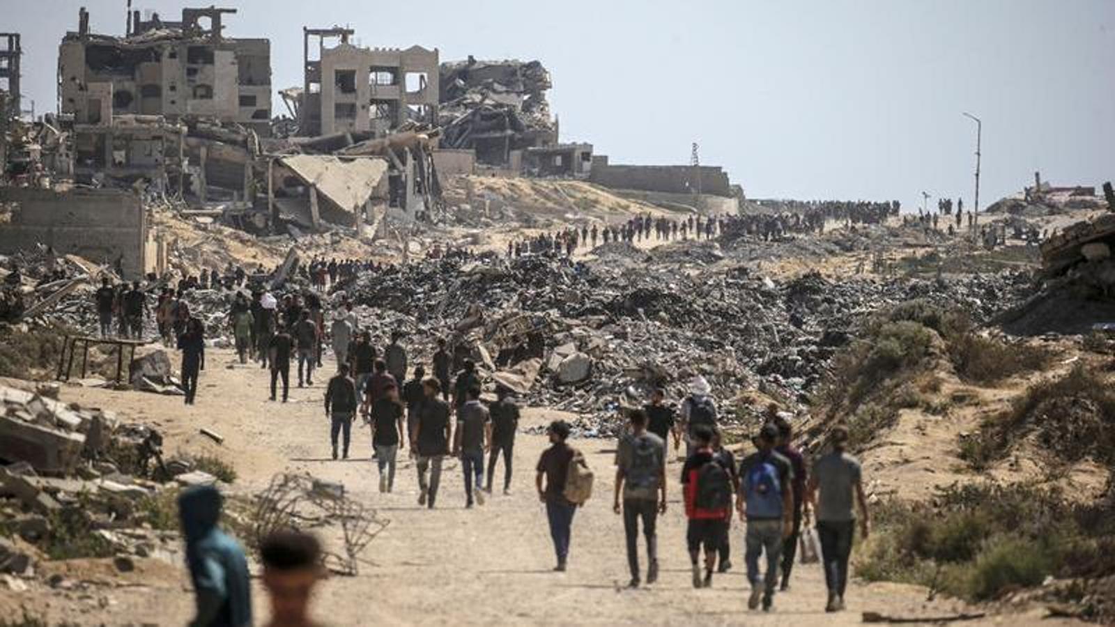 Displaced people in the Gaza Strip walk near Jabalia, July 20.