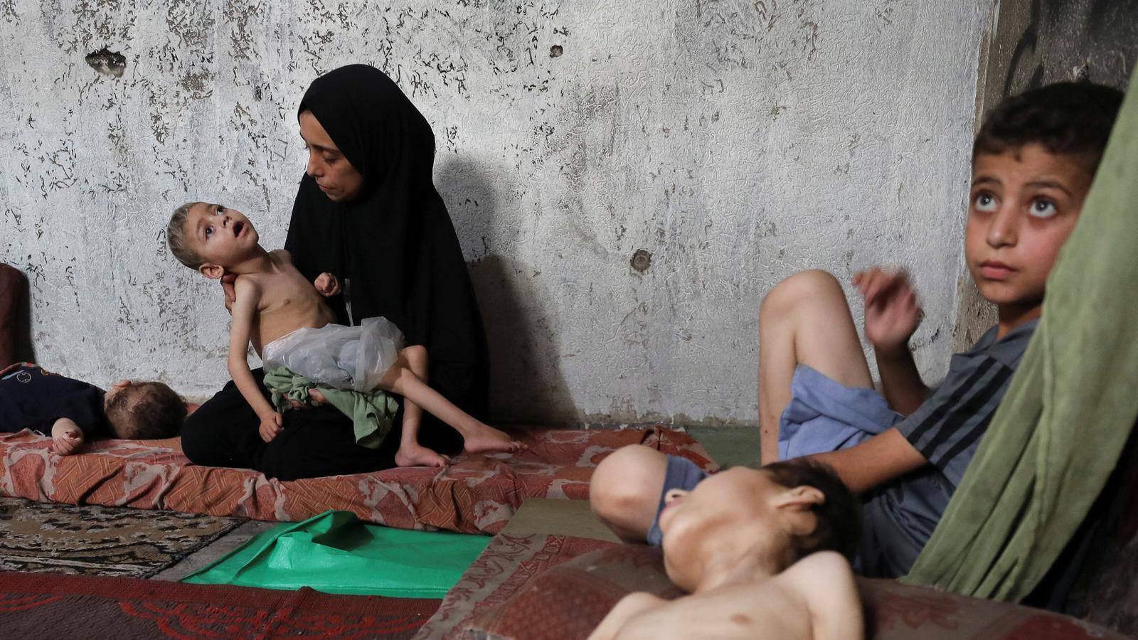Samah Matar holds her malnourished son, Youssef, in Gaza.