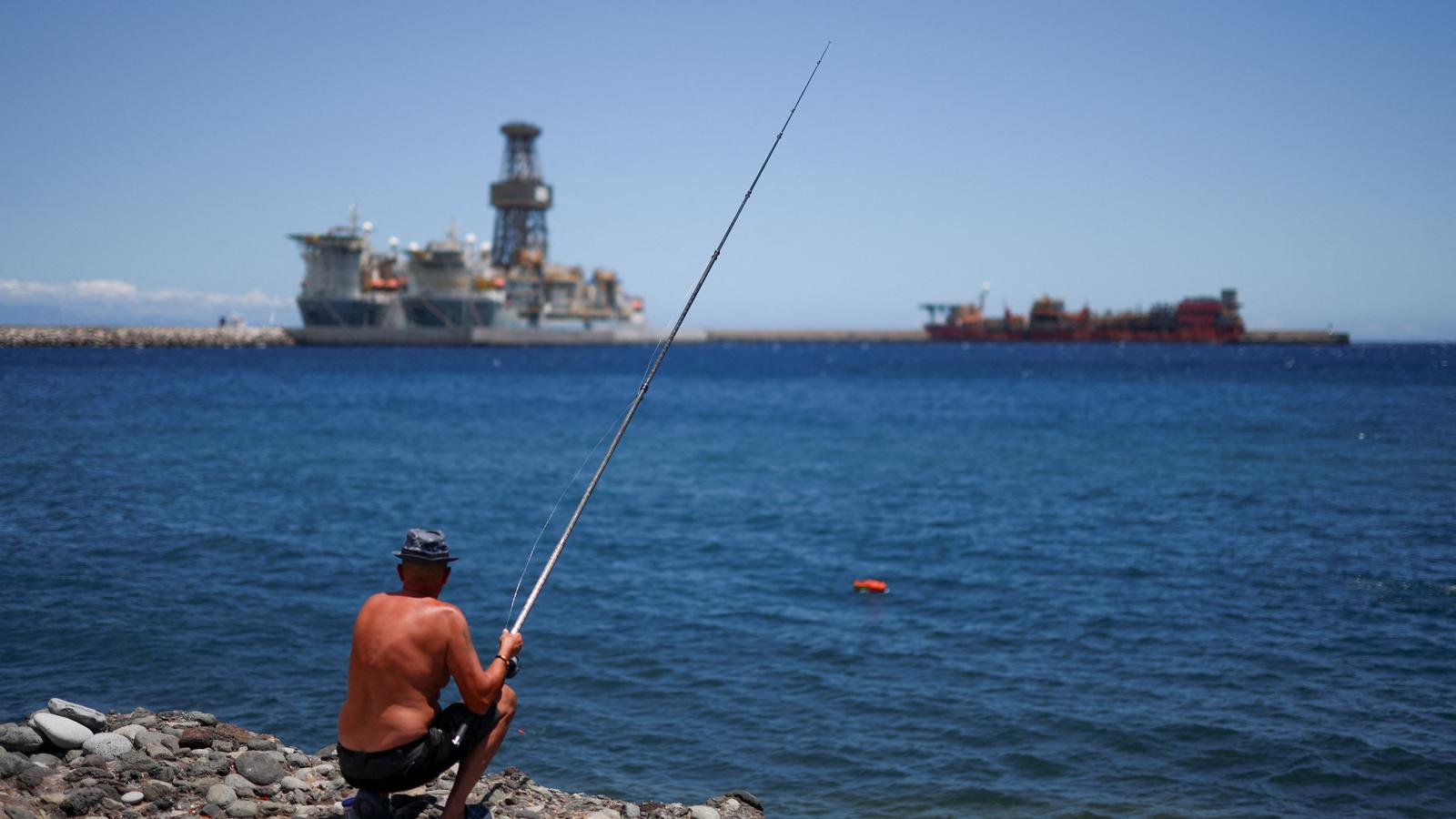 A man fishing in the port of Granadilla, where the hantavirus ship is expected to be anchored.
