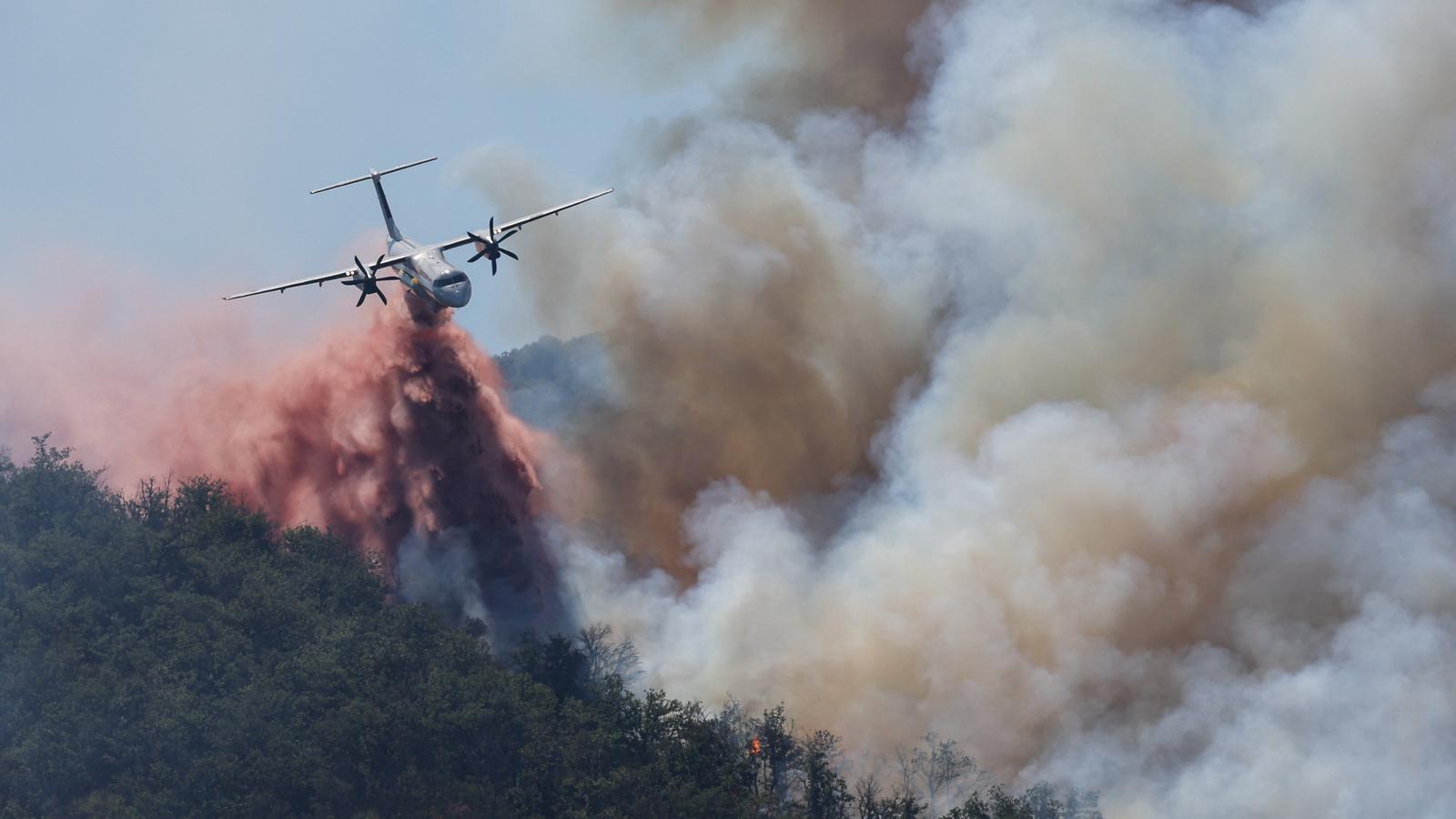 A firefighting plane drops water on the forest fire in Ille-sur-Têt, near Perpignan (France), on July 6, 2026.