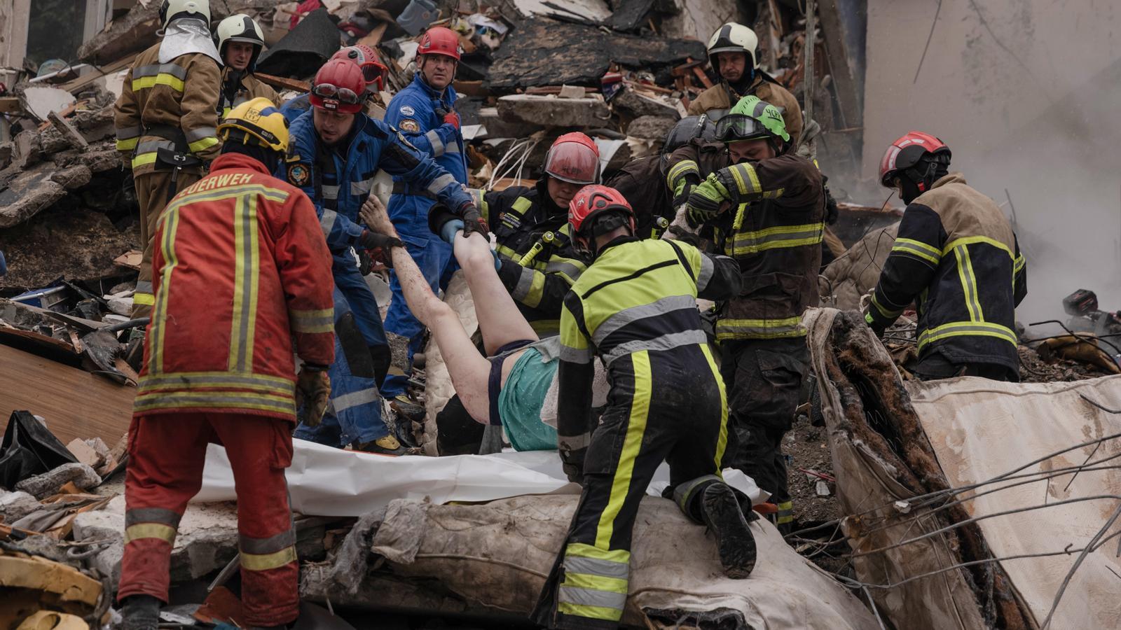 Rescue teams evacuate a woman's body from a destroyed building in kyiv.