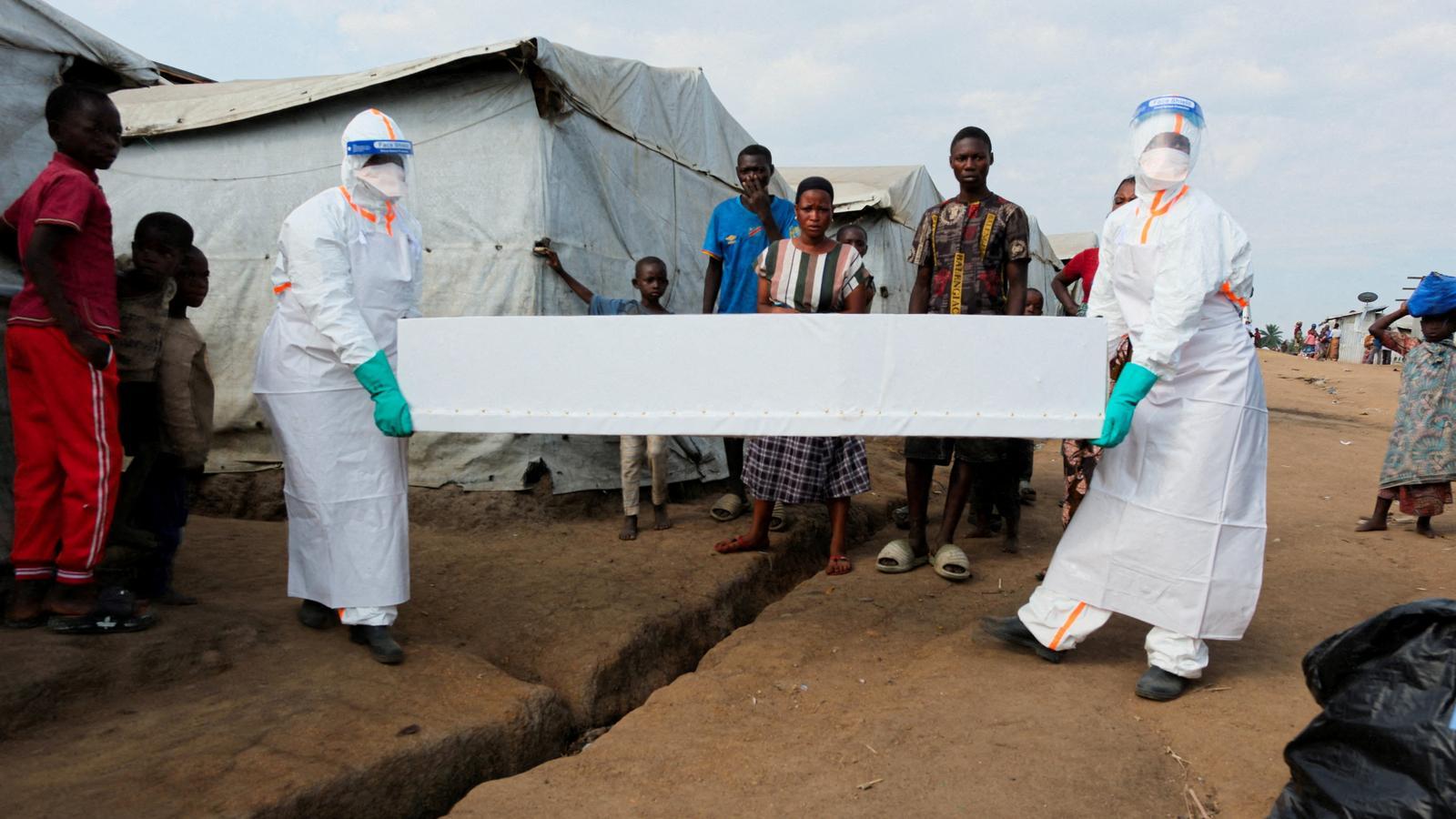 Health workers carry the coffin of a person suspected of dying of Ebola to the displaced persons camp in Kigonze, Bunia, in the east of the Democratic Republic of Congo.