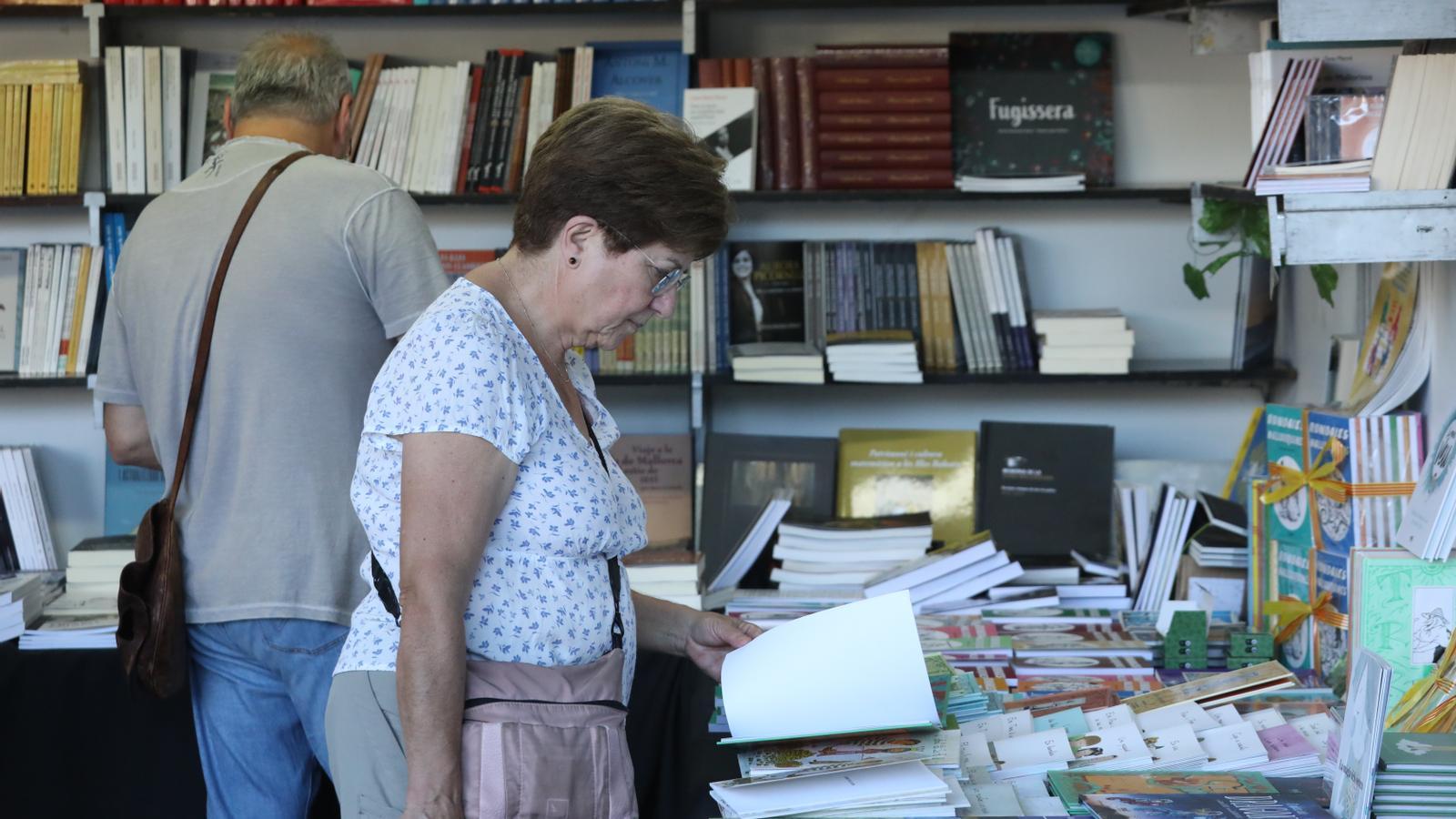 A woman looks for books to buy during a fair.