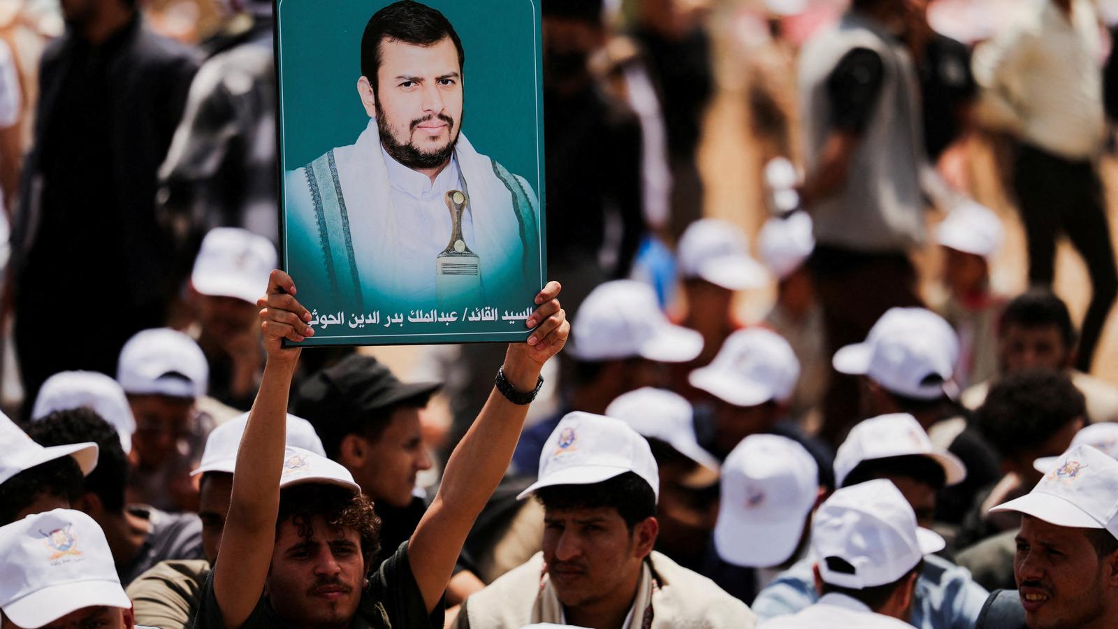 A student holds an image of the Houthi leader Abdul-Malik during a rally at the Sanaa University campus in support of the Yemeni group on July 22.