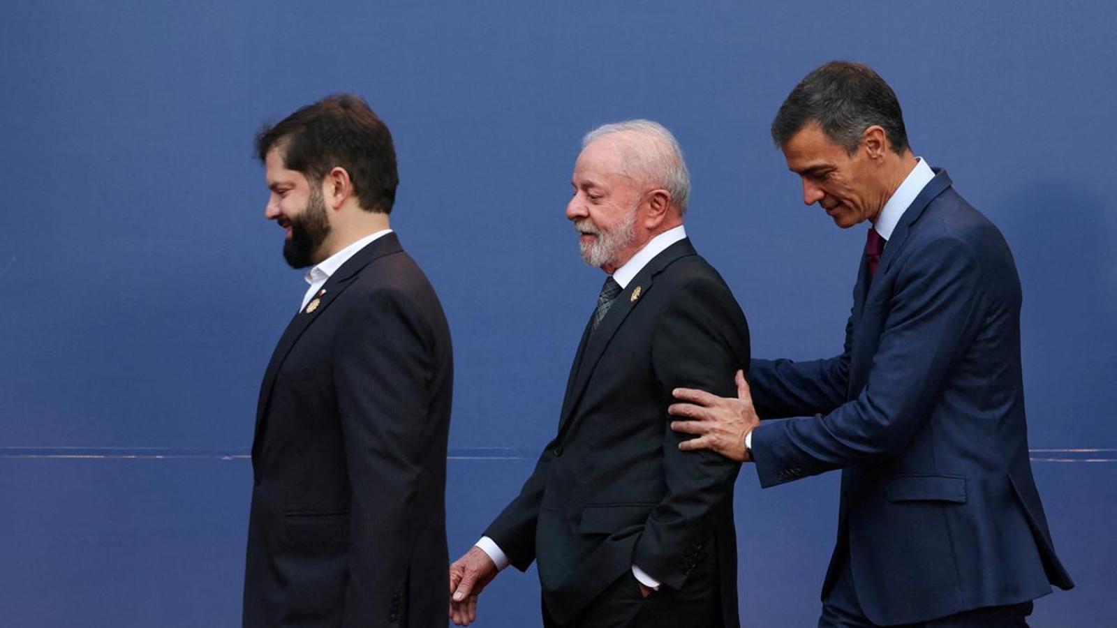 Gabriel Boric, Lula da Silva, and Pedro Sánchez walk together before taking a family photo during the "Democracy Always" meeting in Chile.