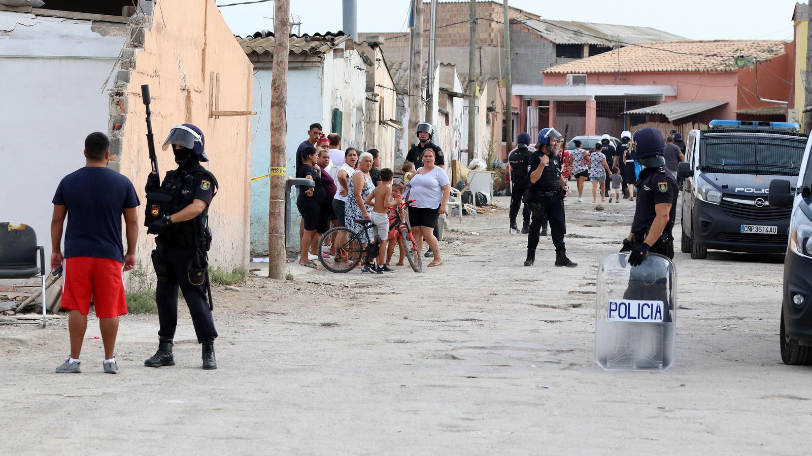 Police officers and residents of the village of Son Banya