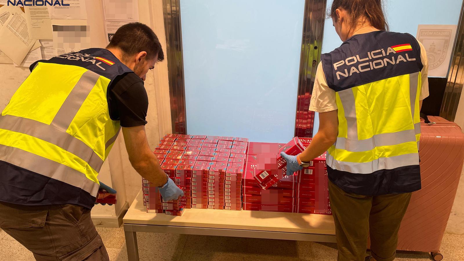 National Police officers with confiscated packets of tobacco