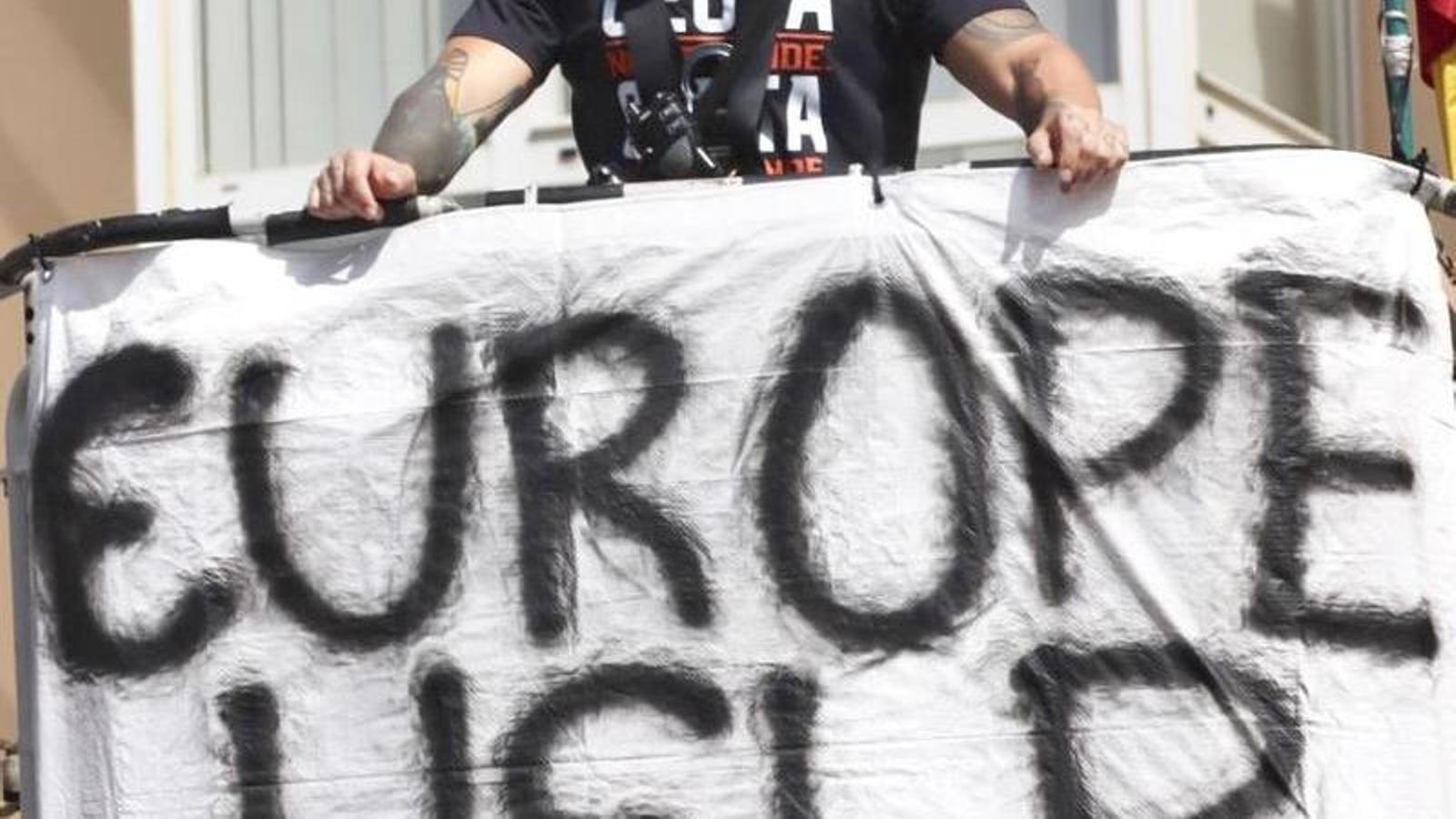A firefighter from Ceuta with a banner asking for "help from Europe" to overcome the migratory crisis.