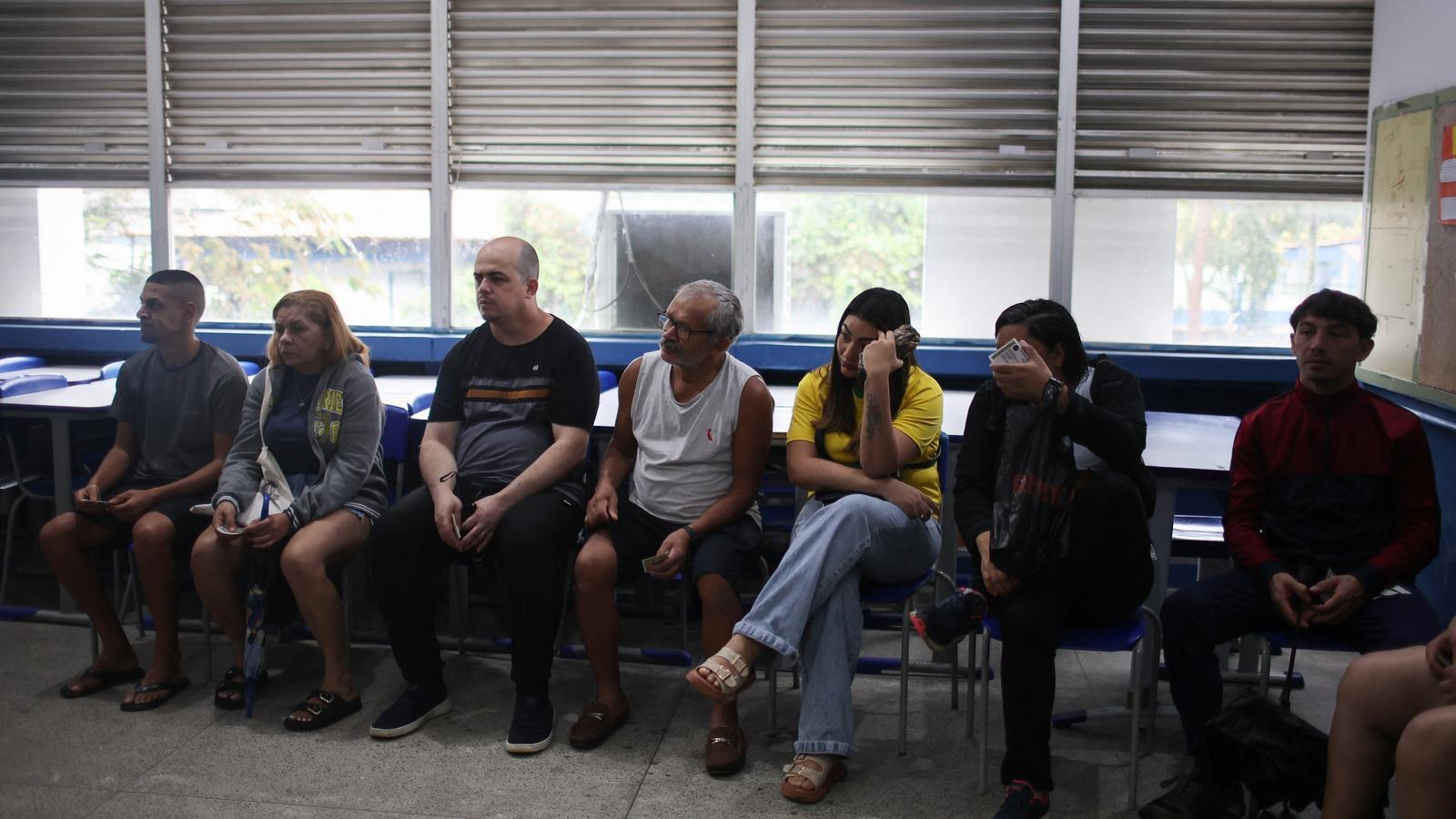 Voters wait to vote at a polling station in the Rocinha favela, in Rio de Janeiro.
