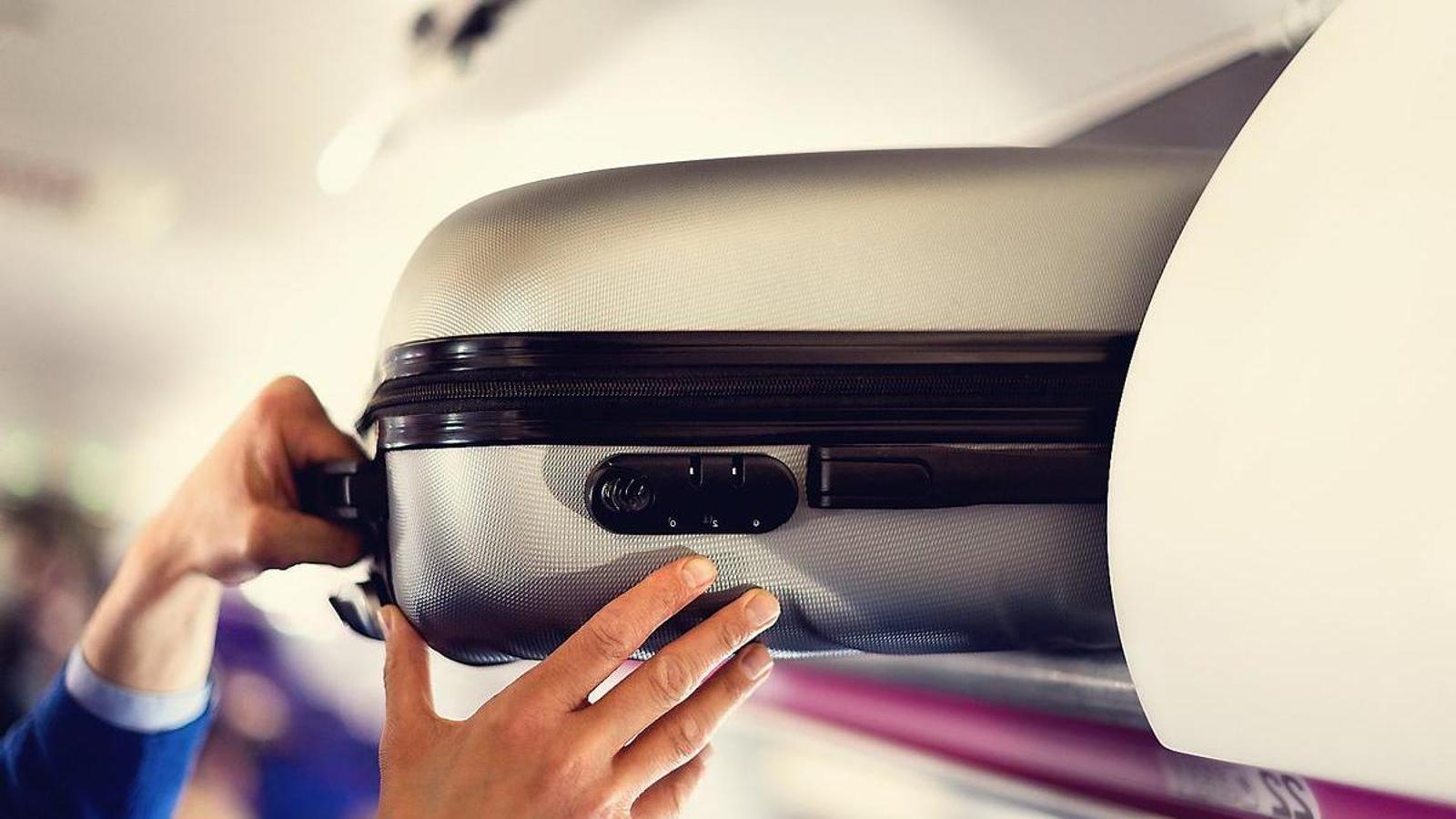 A carry-on suitcase in a plane's luggage compartment.