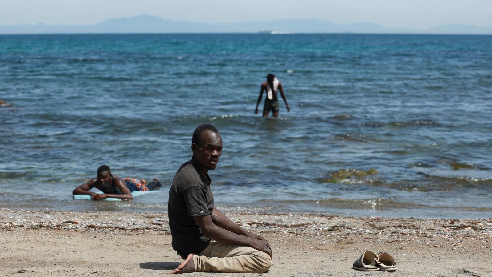 A migrant on the beach in Ceuta after crossing from Morocco.