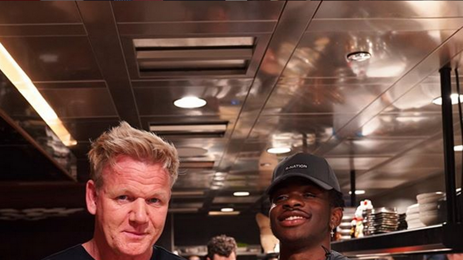 Chef Gordon Ramsay, left, accompanied by one of his workers