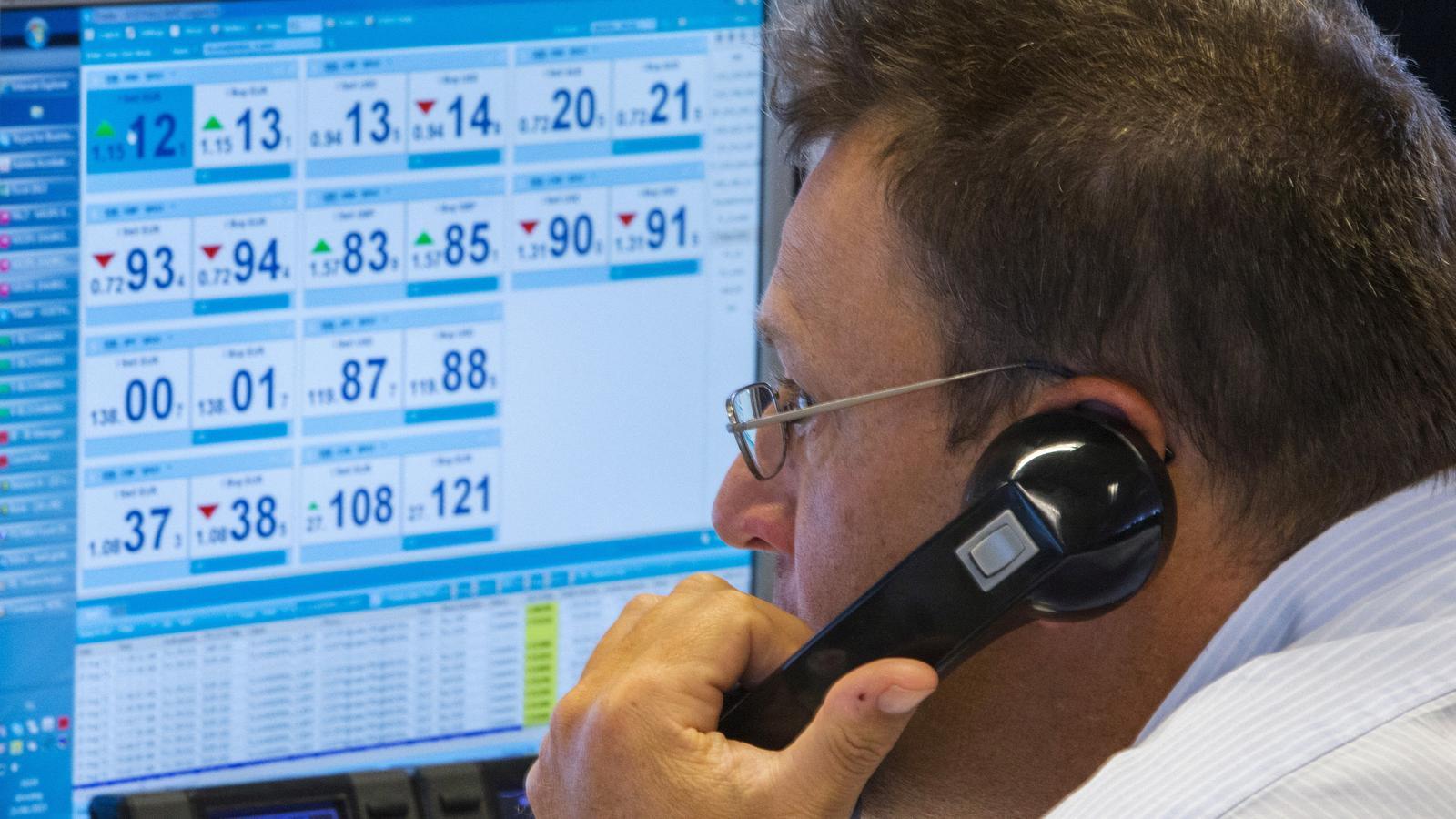 An operator looks at the screens of the trading room of the KBC bank in Brussels.