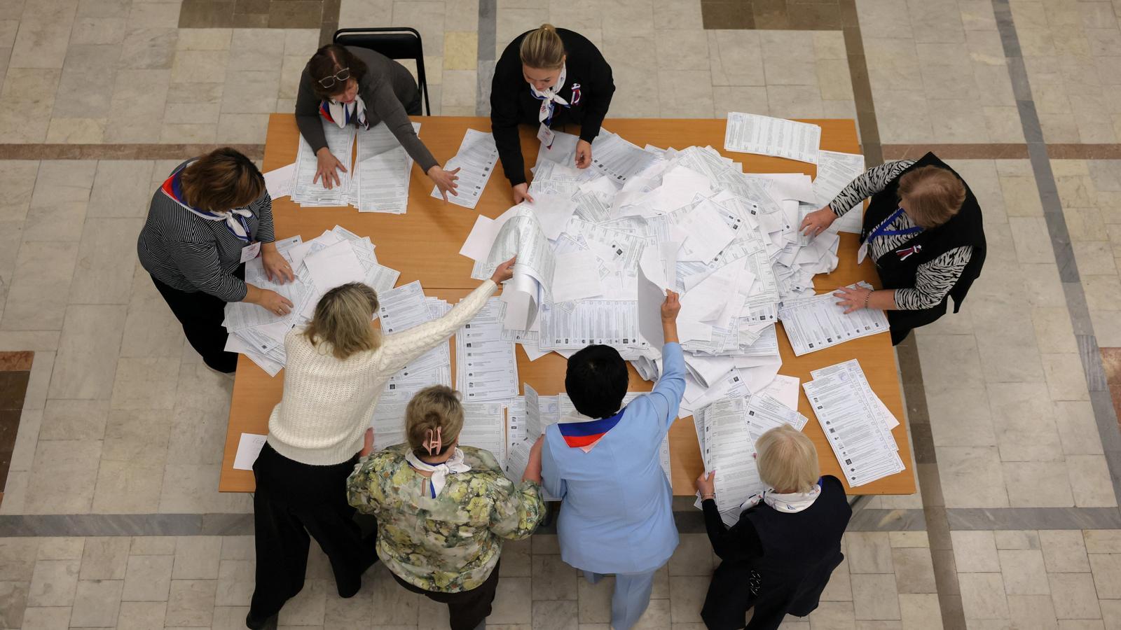 Members of a local election commission count the votes after the closing of a polling station on the last day of the three-day parliamentary elections in Russia, in the city of Podolsk, near Moscow, Russia.
