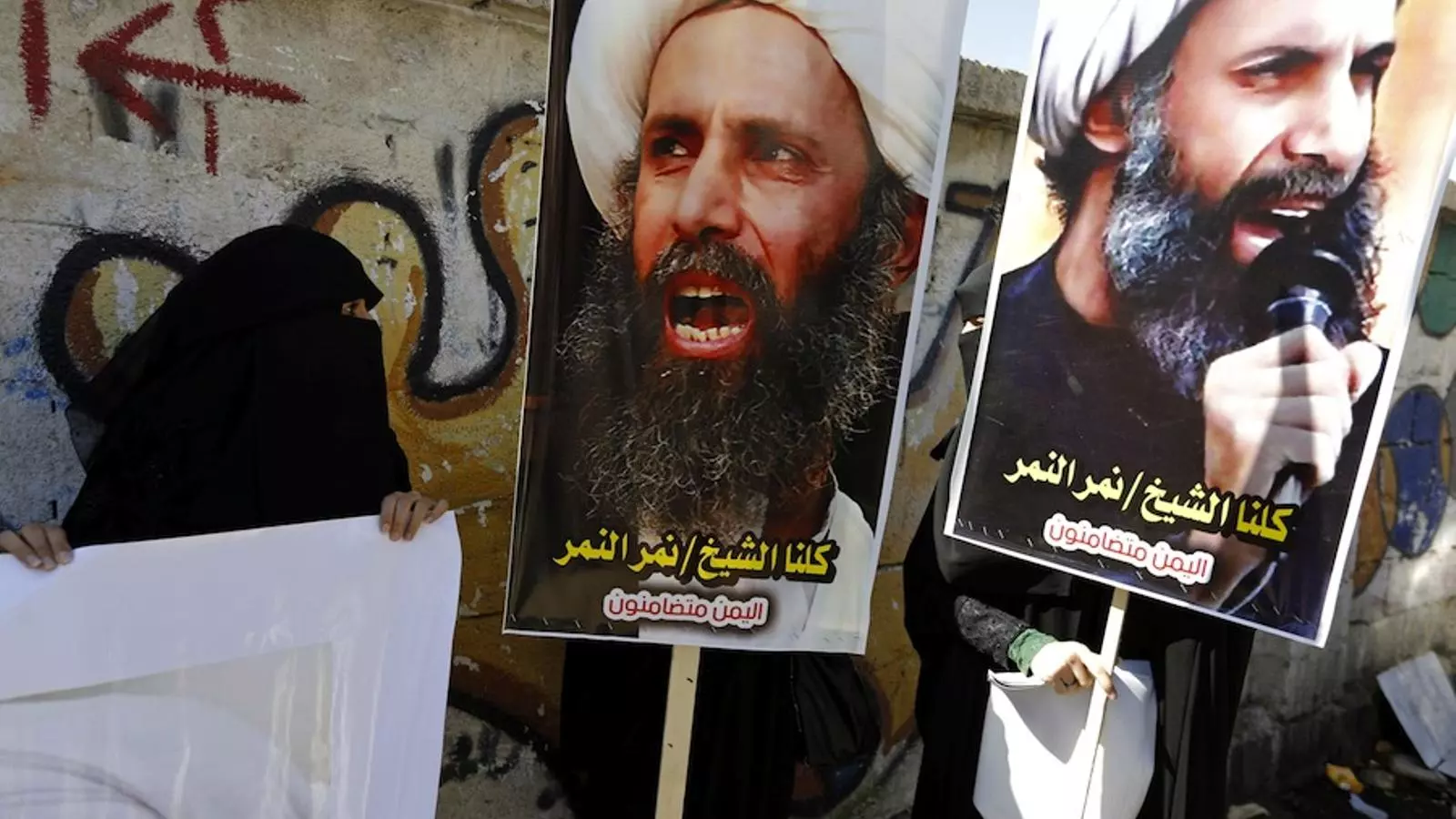 Manifestants a l'ambaixada saudita de Sanà, amb posters on es llegeix "tots som el xeic Nimr al-Nimr, l'octubre de 2014, quan va ser condemnat a mort. KHALED ABDULLAH / REUTERS