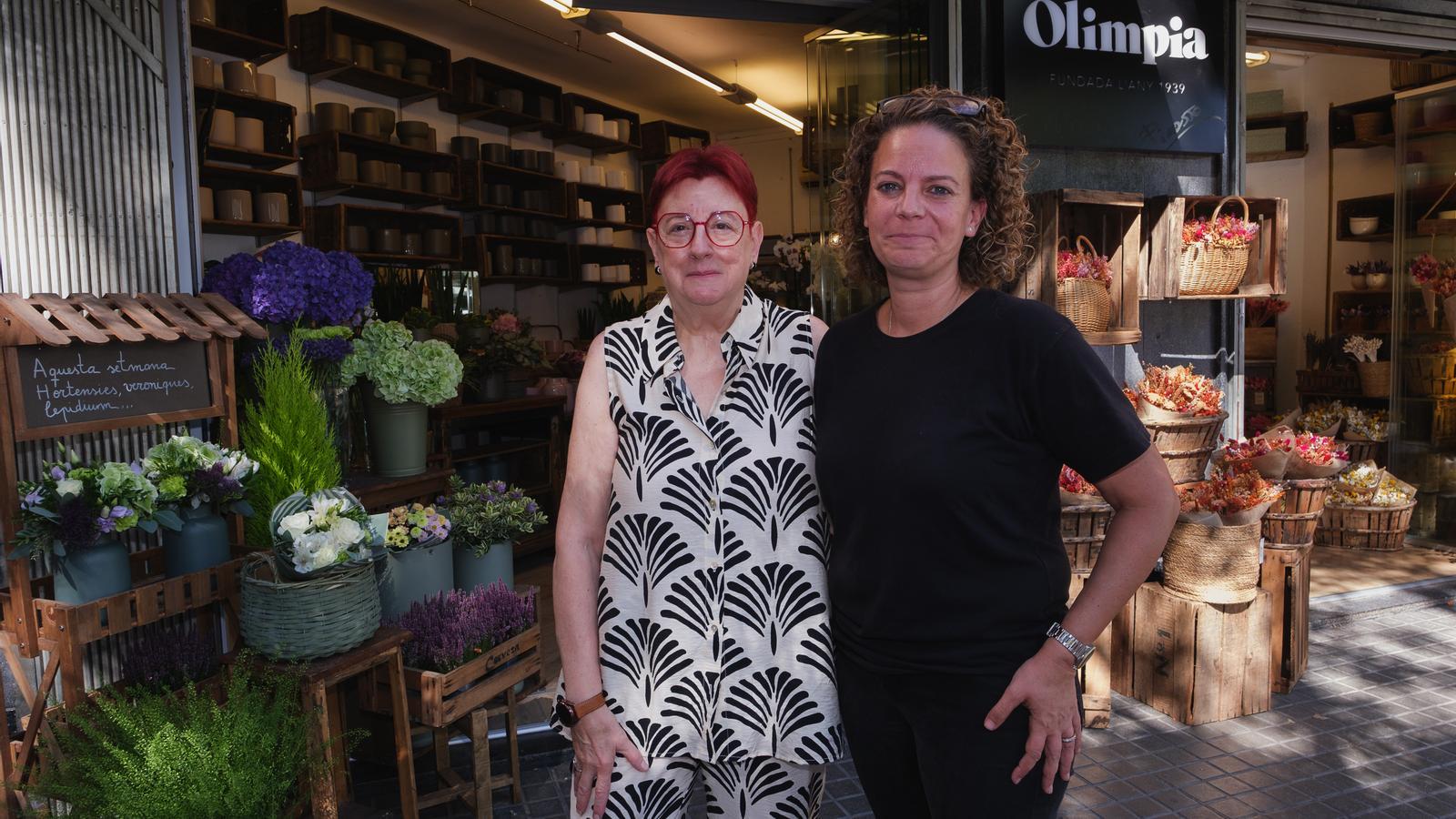 The owners of the Olimpia flower shop photographed in front of the store.