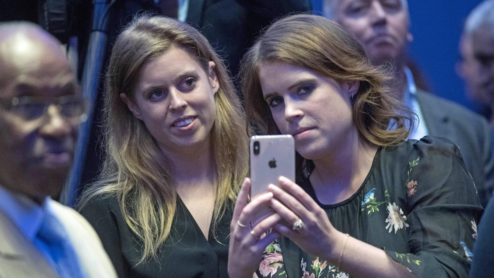 Beatrice and Eugenie of York taking a photo at the United Nations