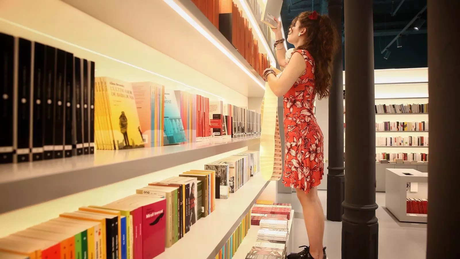 Una treballadora d'Ona Llibres ordenant les prestatgeries
