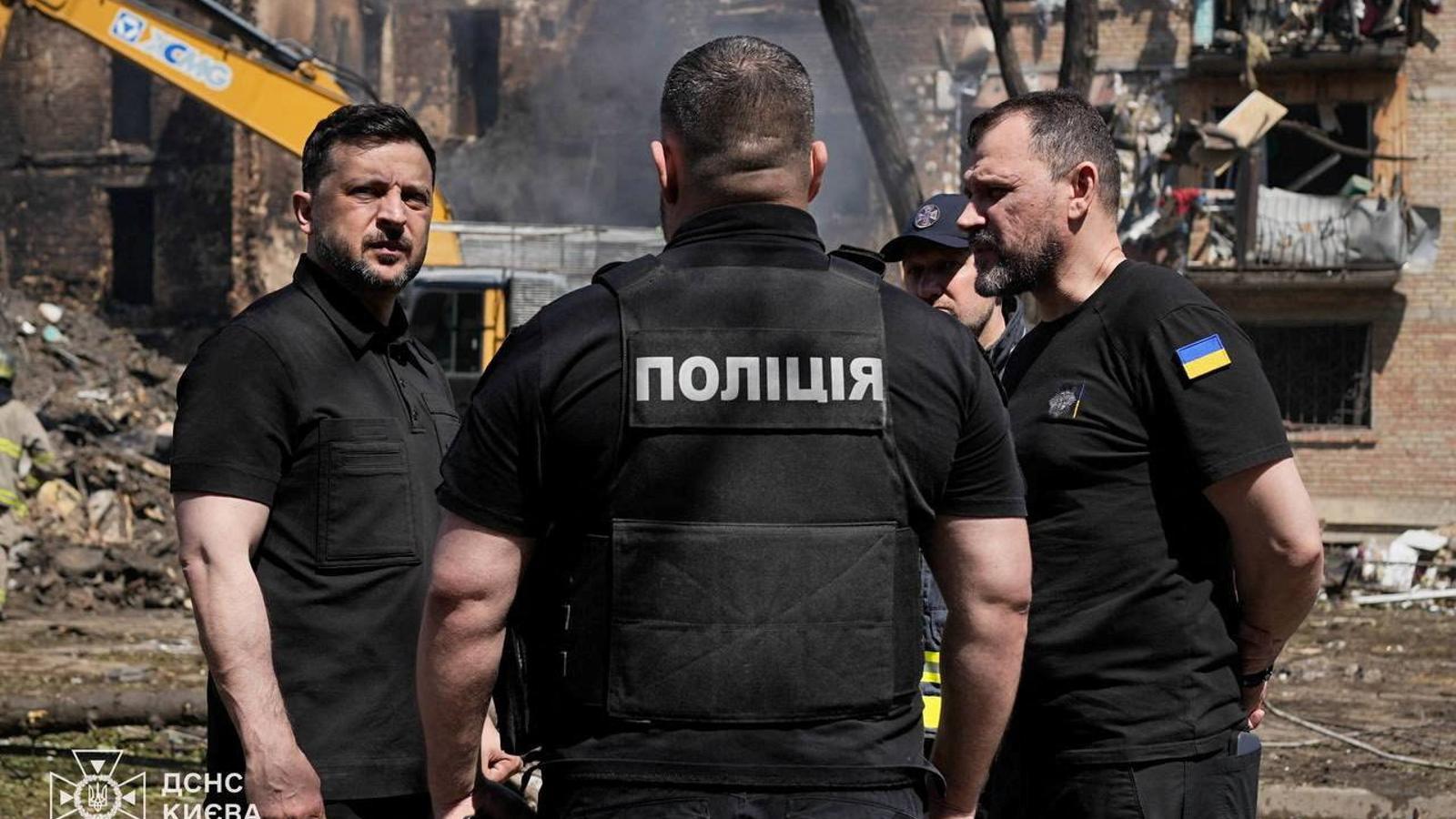 Volodymyr Zelensky visits an apartment building damaged by a Russian missile and drone attack on May 24 in Kyiv, Ukraine.