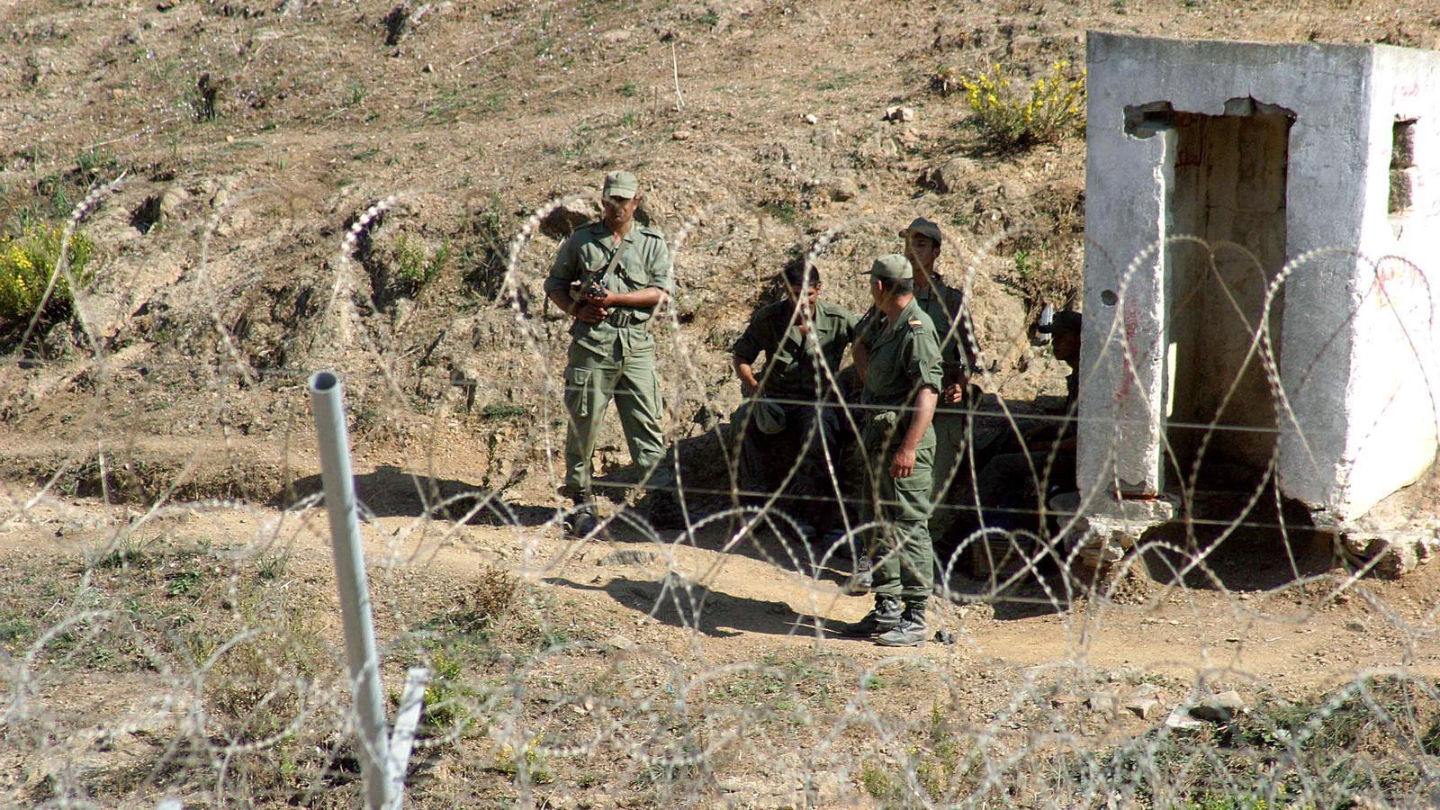 A group of Moroccan soldiers watch the border perimeter between Ceuta and Morocco.