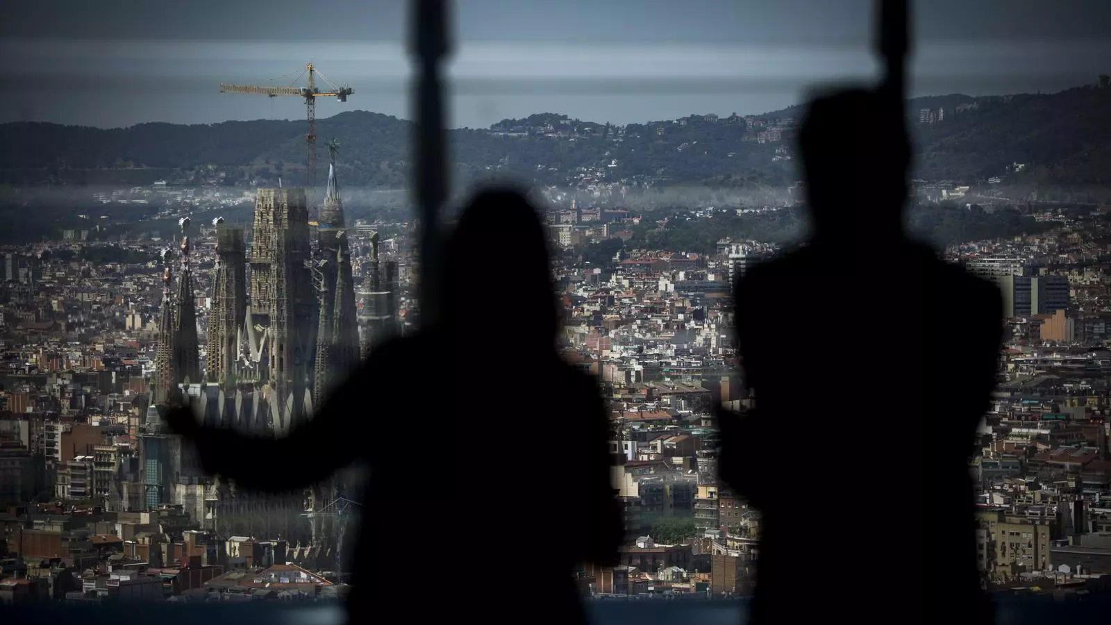 Dos personas mirando la Sagrada Familia desde el nuevo mirador de la Tueste Glorias