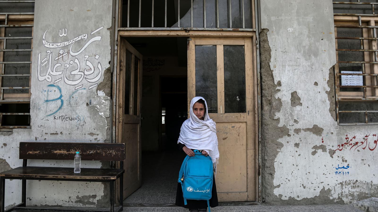 A girl, with her school backpack in front of an educational center in Kabul on March 22.