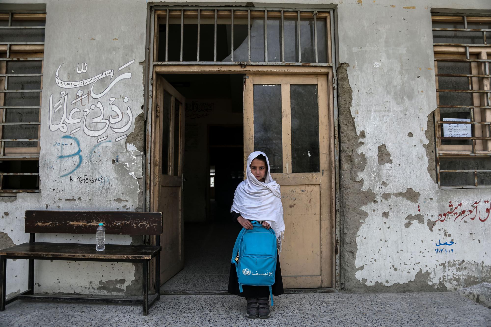 A girl, with her school backpack in front of an educational center in Kabul on March 22.
