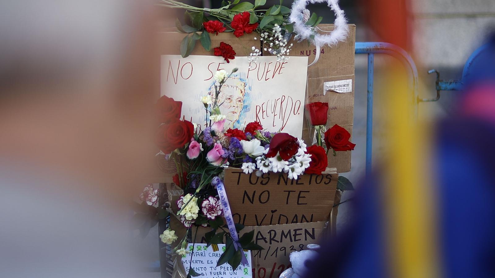 Flowers and posters in memory of Maricarmen Abascal, at the Madrid encampment.