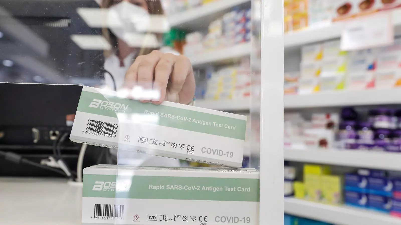 Una farmacèutica venent un test d'antígens.