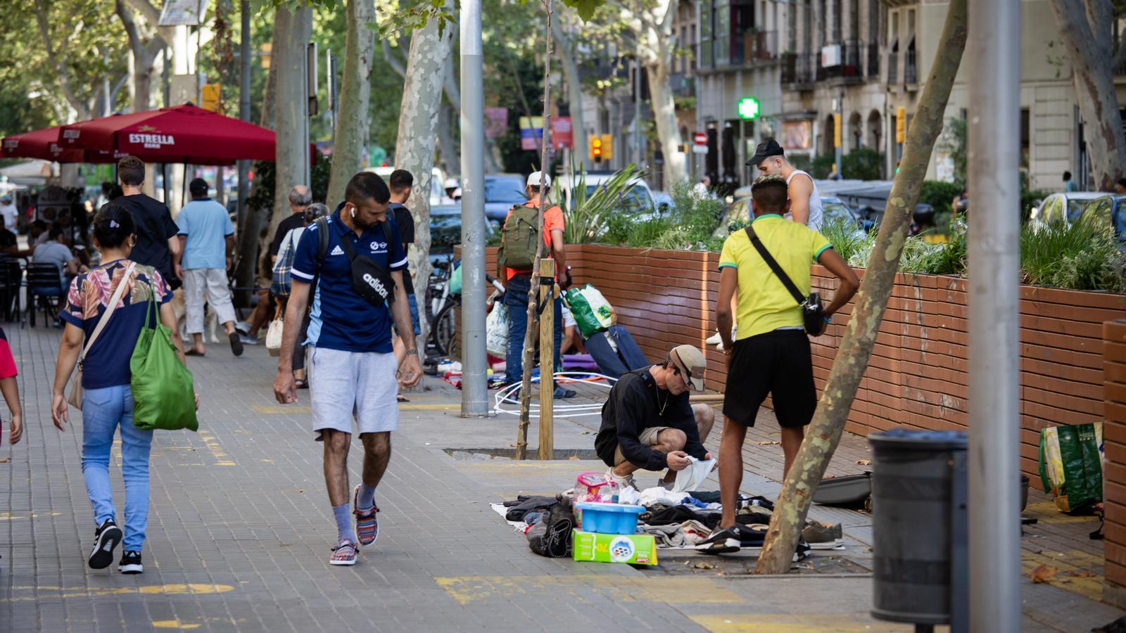 A man selling objects on the street in the Sant Antoni neighborhood of Barcelona