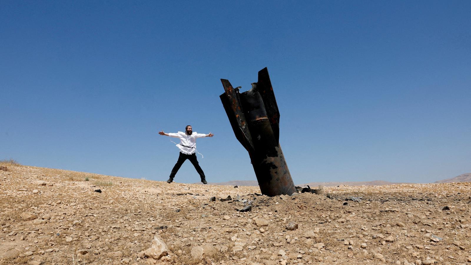 An ultra-Orthodox Jew next to a missile after Iran's attacks, in the Israeli-occupied West Bank, on June 8.