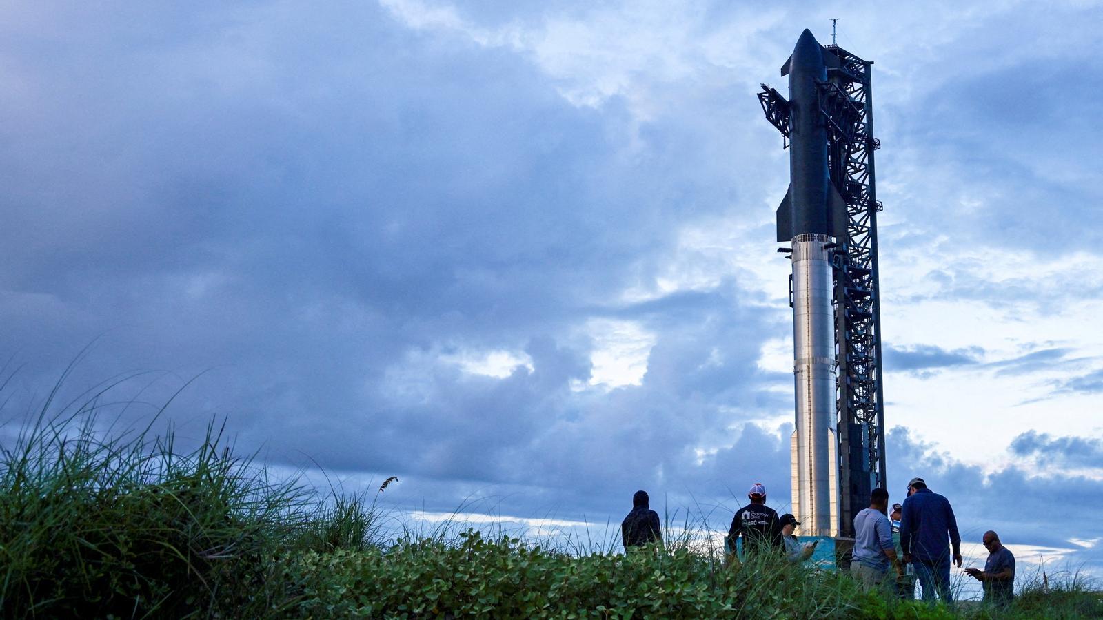 Spectators watch preparations for the launch of a SpaceX ship on Monday.