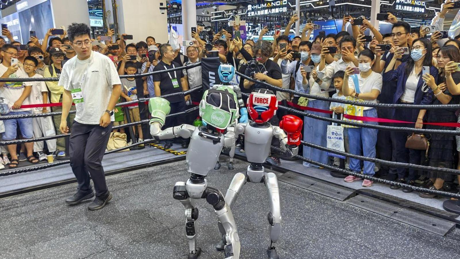 Humanoid robots participating in a boxing match at a world technology congress in Shanghai.