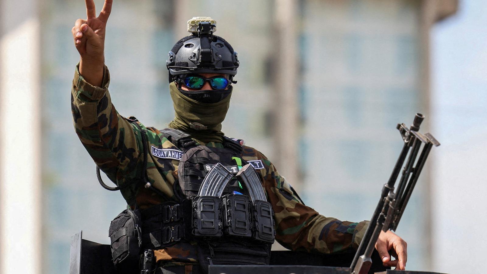 A member of the Iraqi security forces celebrates the withdrawal of foreign forces on September 30 in Baghdad.