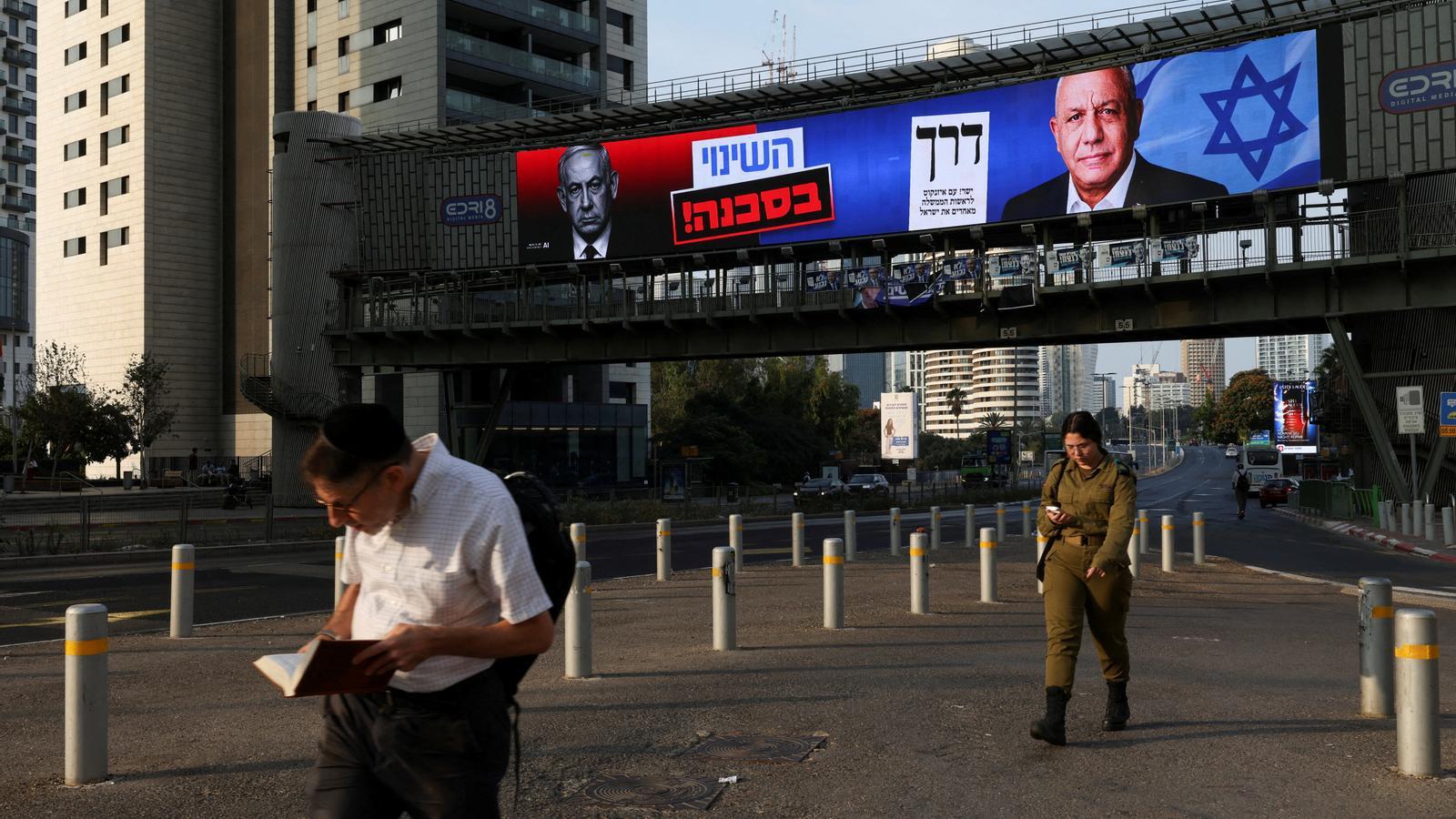 An electoral advertising billboard shows the Prime Minister of Israel and leader of the Likud party, Benjamin Netanyahu, and the former Israeli military chief and leader of the Yashar party, Gadi Eisenkot, in Ramat Gan, Israel.