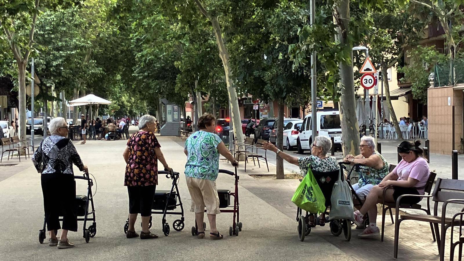 A group of old women chatting on a street in Barcelona.