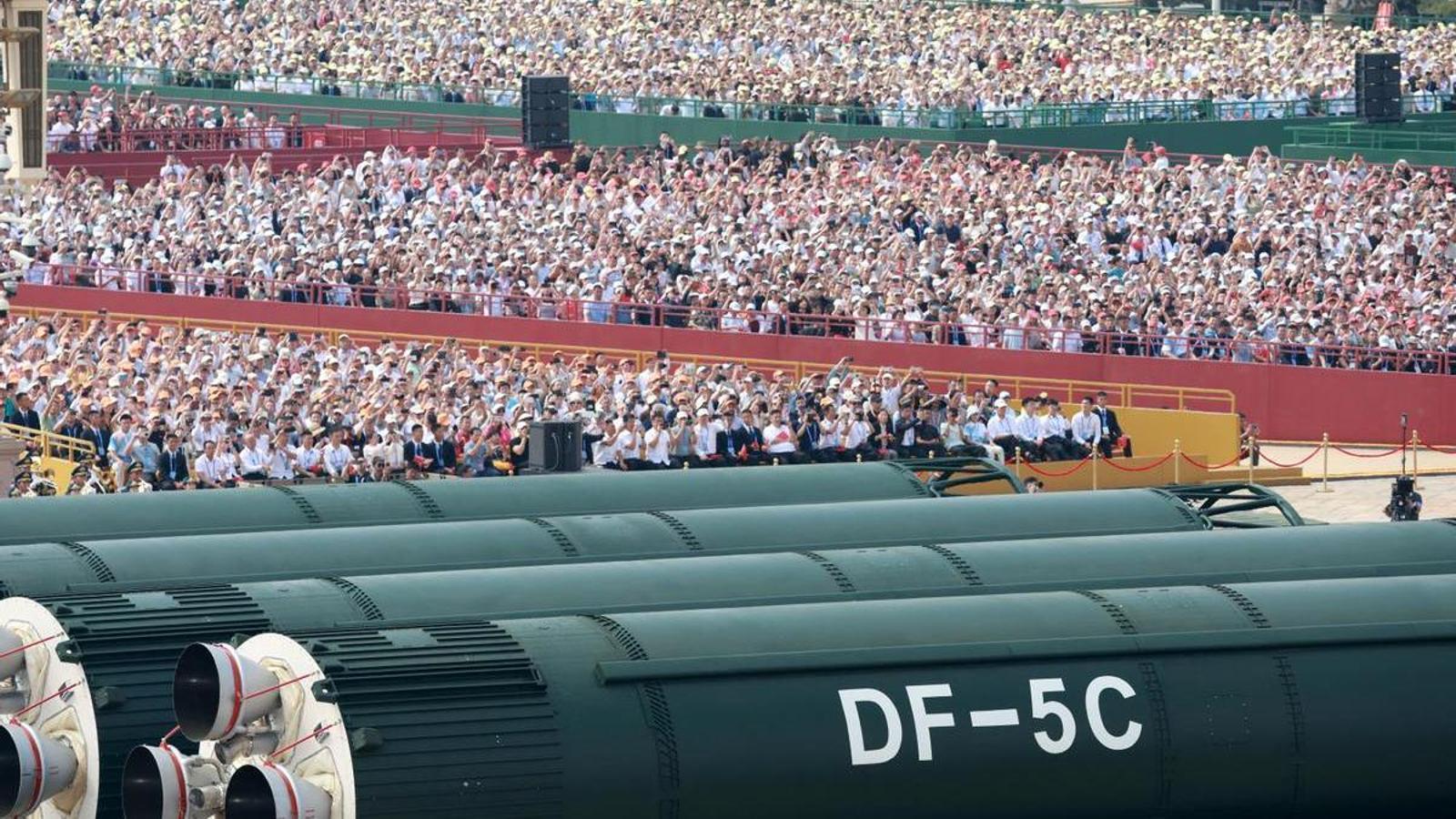 Spectators look at intercontinental ballistic missiles during the military parade to commemorate the 80th anniversary of the end of World War II, in Beijing, September 3, 2025.