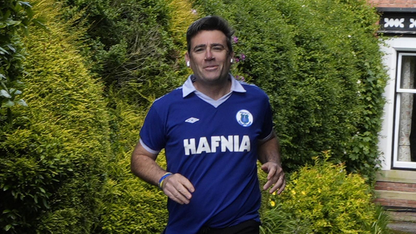 The Mayor of Greater Manchester, Andy Burnham, jogs in front of his house on the 15th, in Warrington, in Greater Manchester.