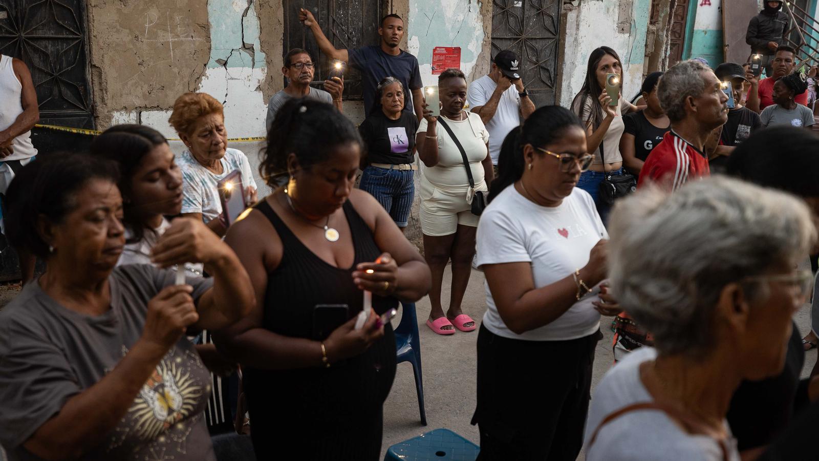 A group of people participate in a tribute to the victims of the earthquake in Catia La Mar, Venezuela.