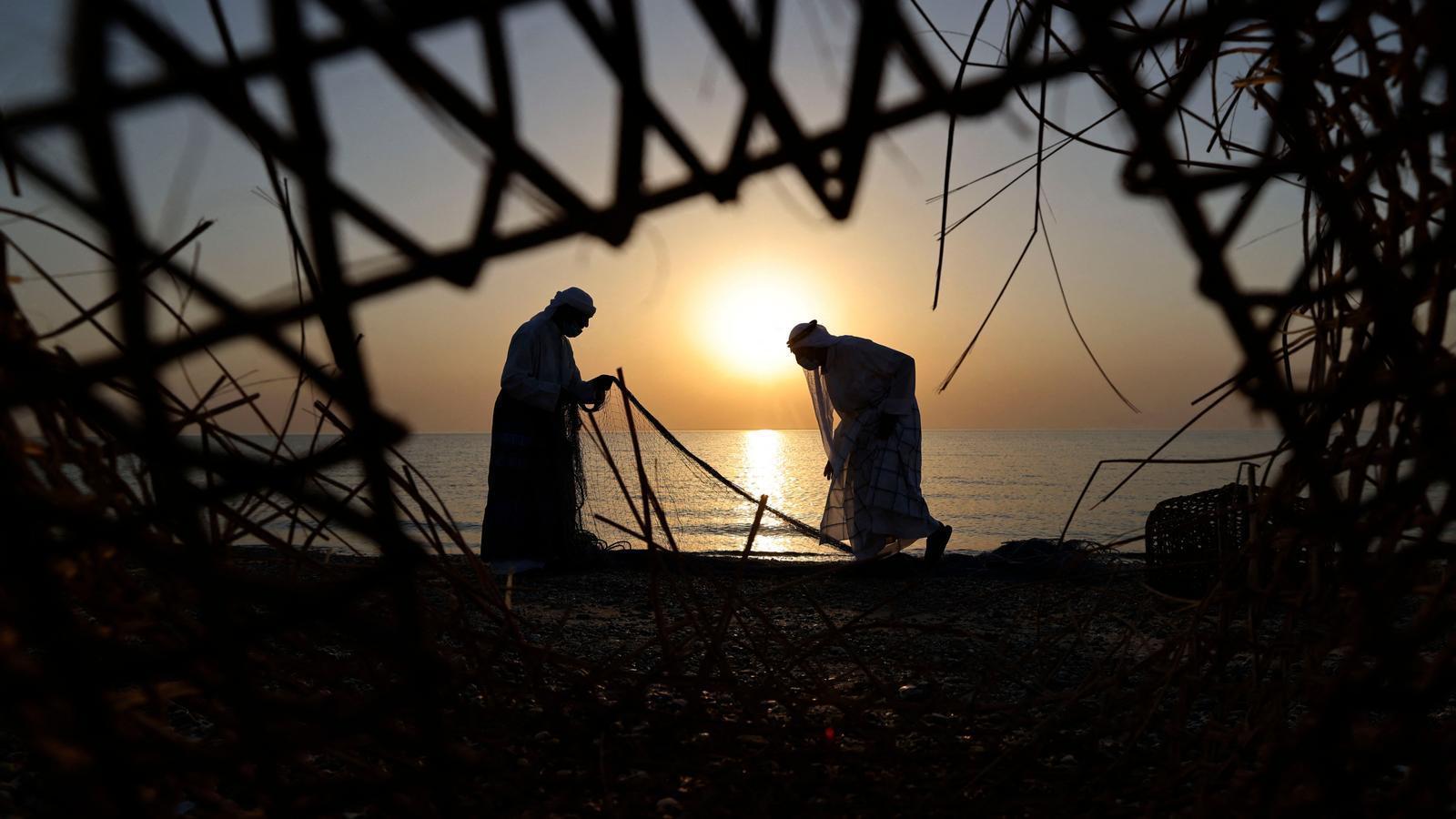 Emirati fishermen backlit