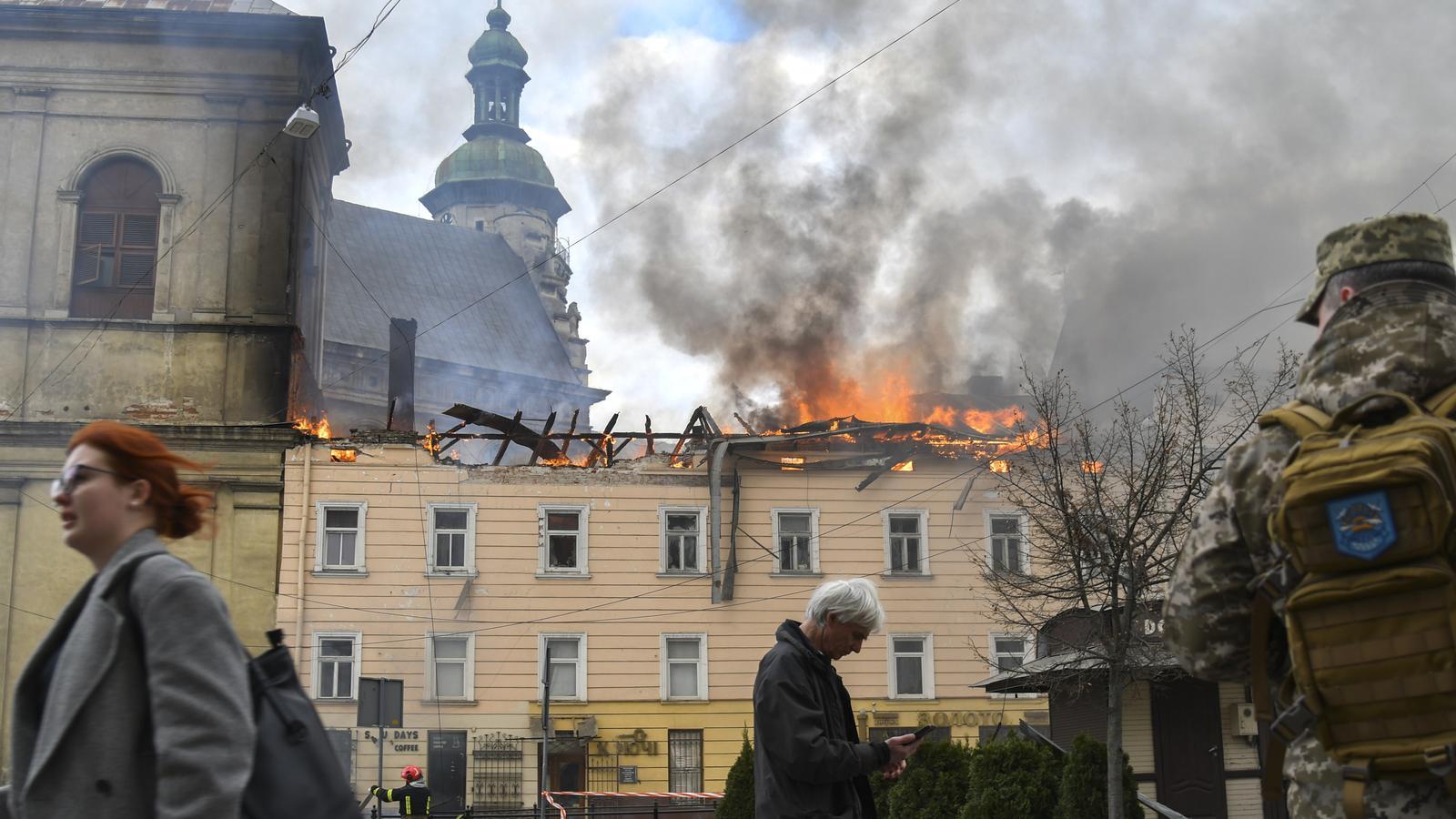Peatones caminan por delante del lugar de un ataque de drones rusos en el centro histórico de Lviv, en el oeste de Ucrania, el 24 de marzo de 2026.