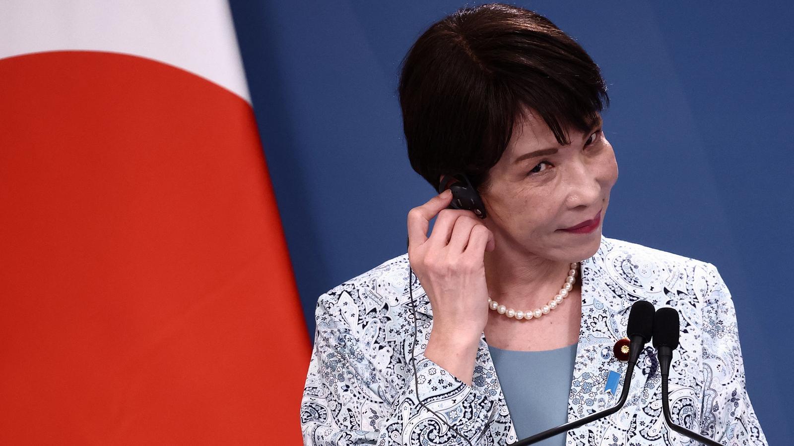 Sanae Takaichi, Japanese Prime Minister, using a simultaneous translation headset.