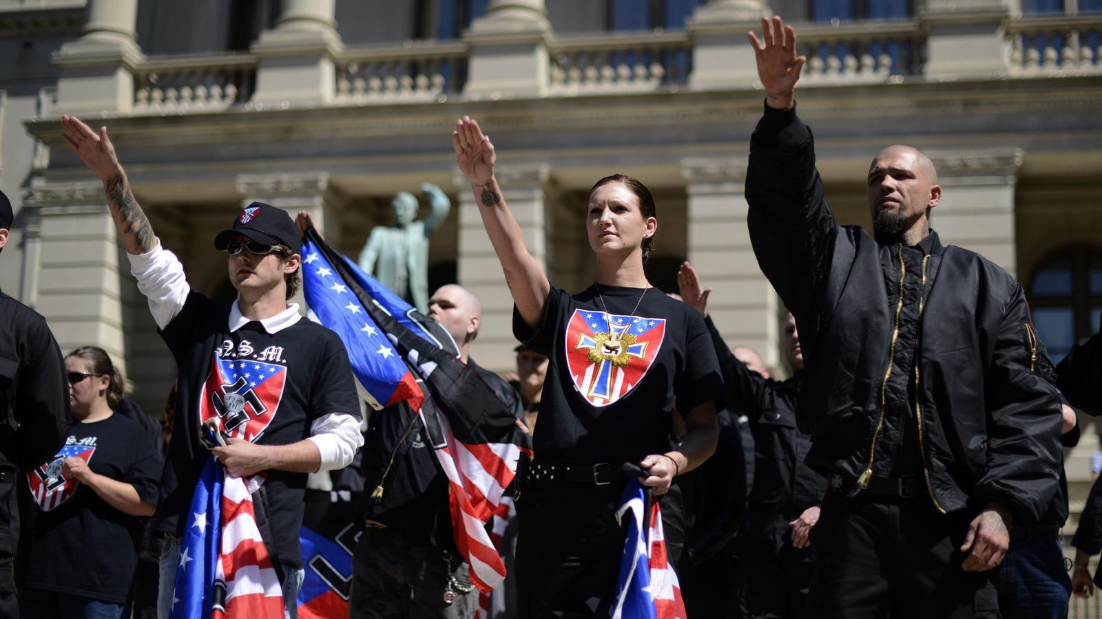 Neo-Nazi protesters, some members of the Ku Klux Klan, perform the Nazi salute while participating in a rally against illegal immigration in Atlanta, Georgia, USA, on April 20, 2013.