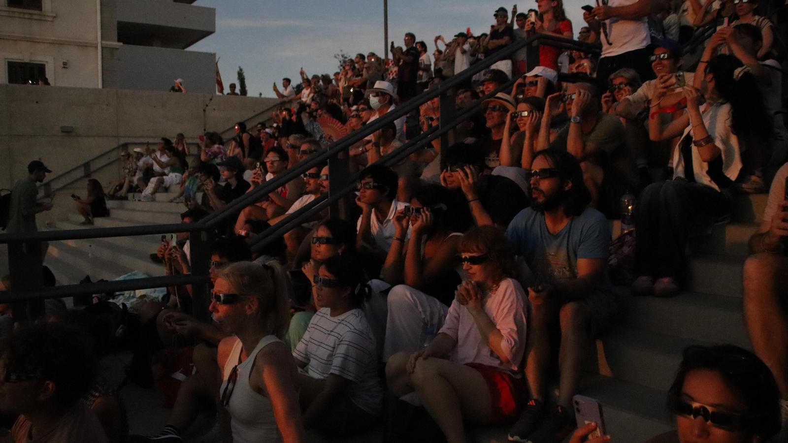 Several people follow the eclipse shortly before totality is reached.