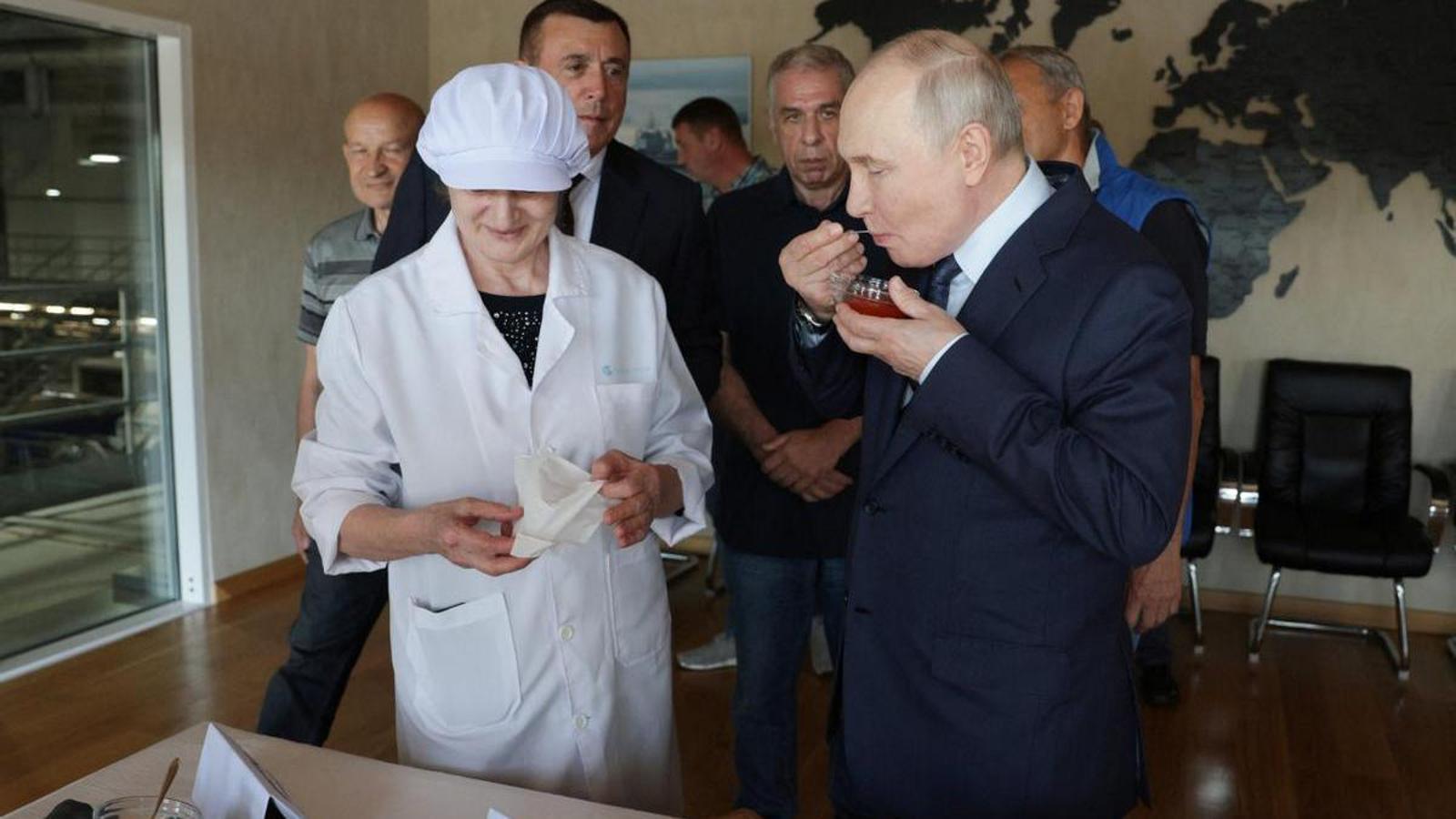 The Russian president, Vladimir Putin, tries caviar during his visit to a fish processing center on the island of Iturup, in the Kuril Islands archipelago.