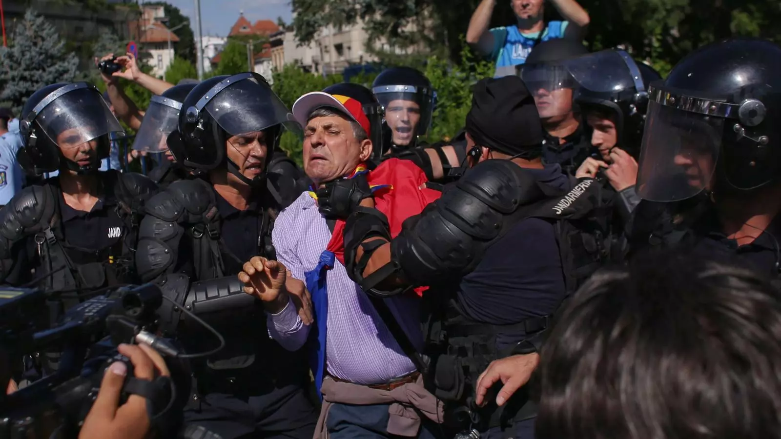 Els agents de policia agafen de forma violenta un dels manifestants, ahir a Bucarest.