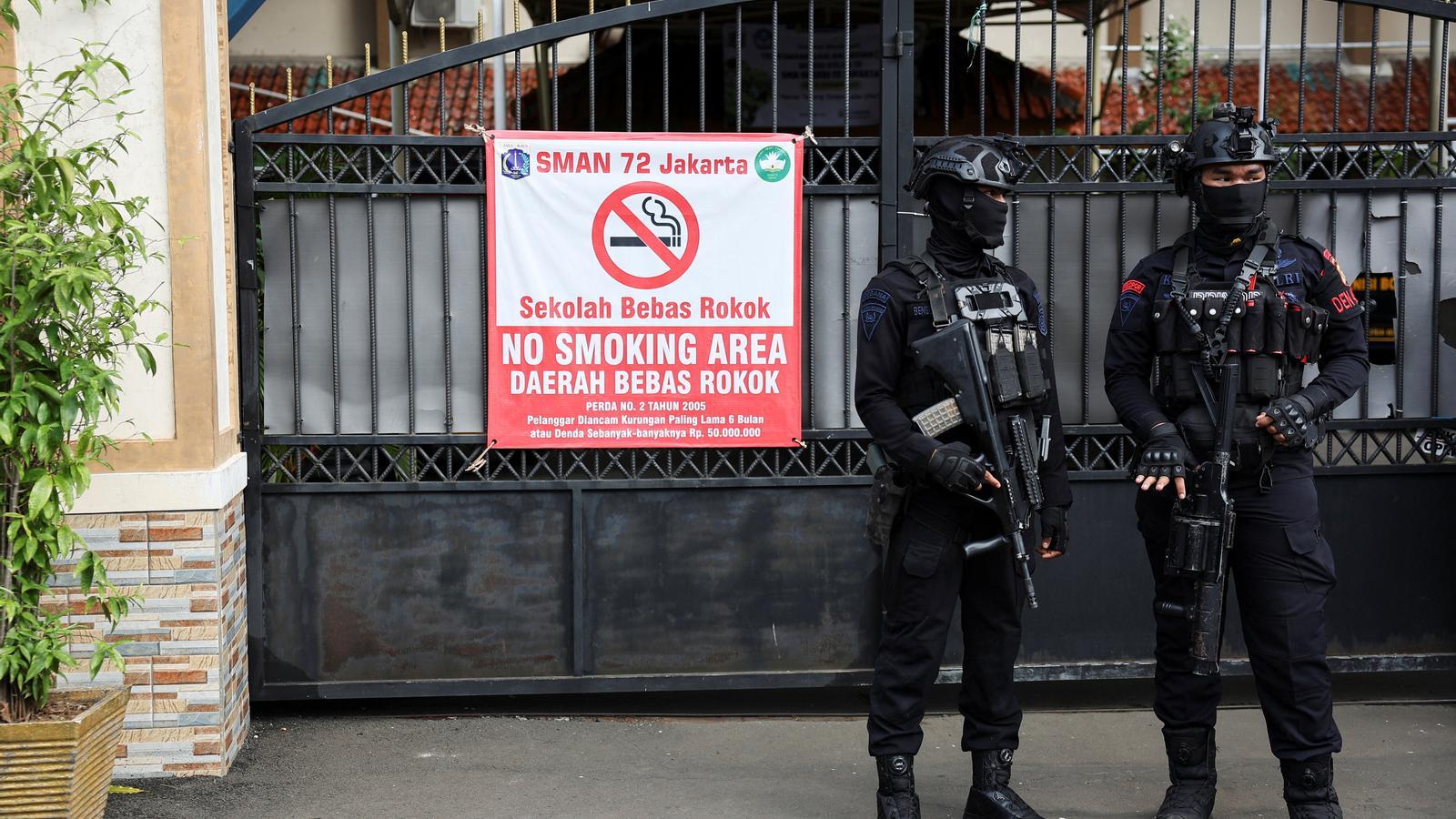 Armed police officers stand guard outside the mosque where an explosion took place at a school complex in Jakarta, Indonesia, on November 7, 2025.