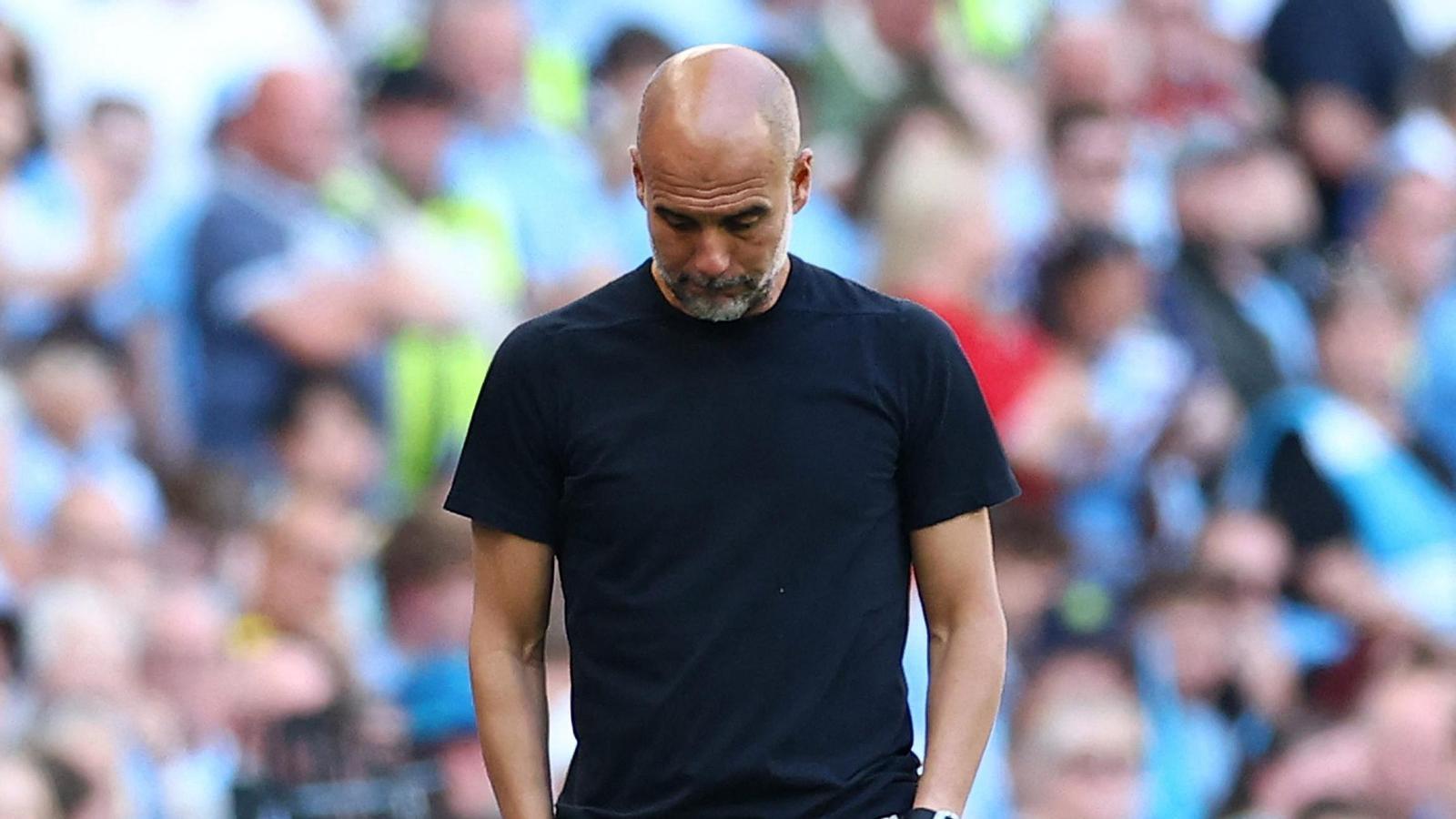 Pep Guardiola staring down at the ground during the FA Cup final on Saturday, May 17.