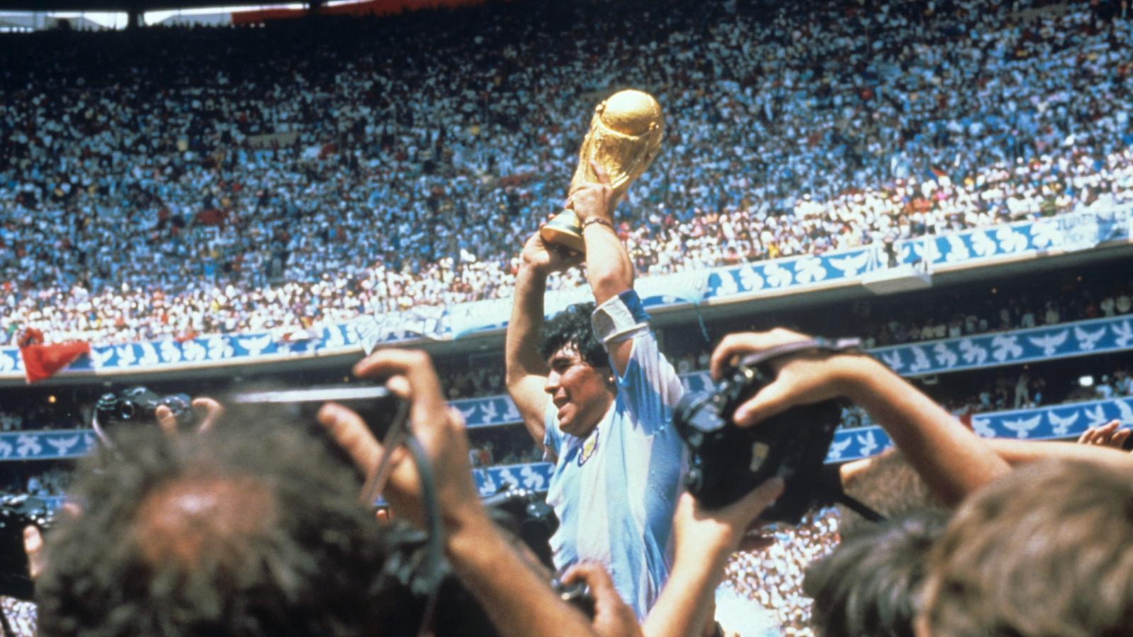 Maradona with the 1986 World Cup at the Azteca stadium in Mexico